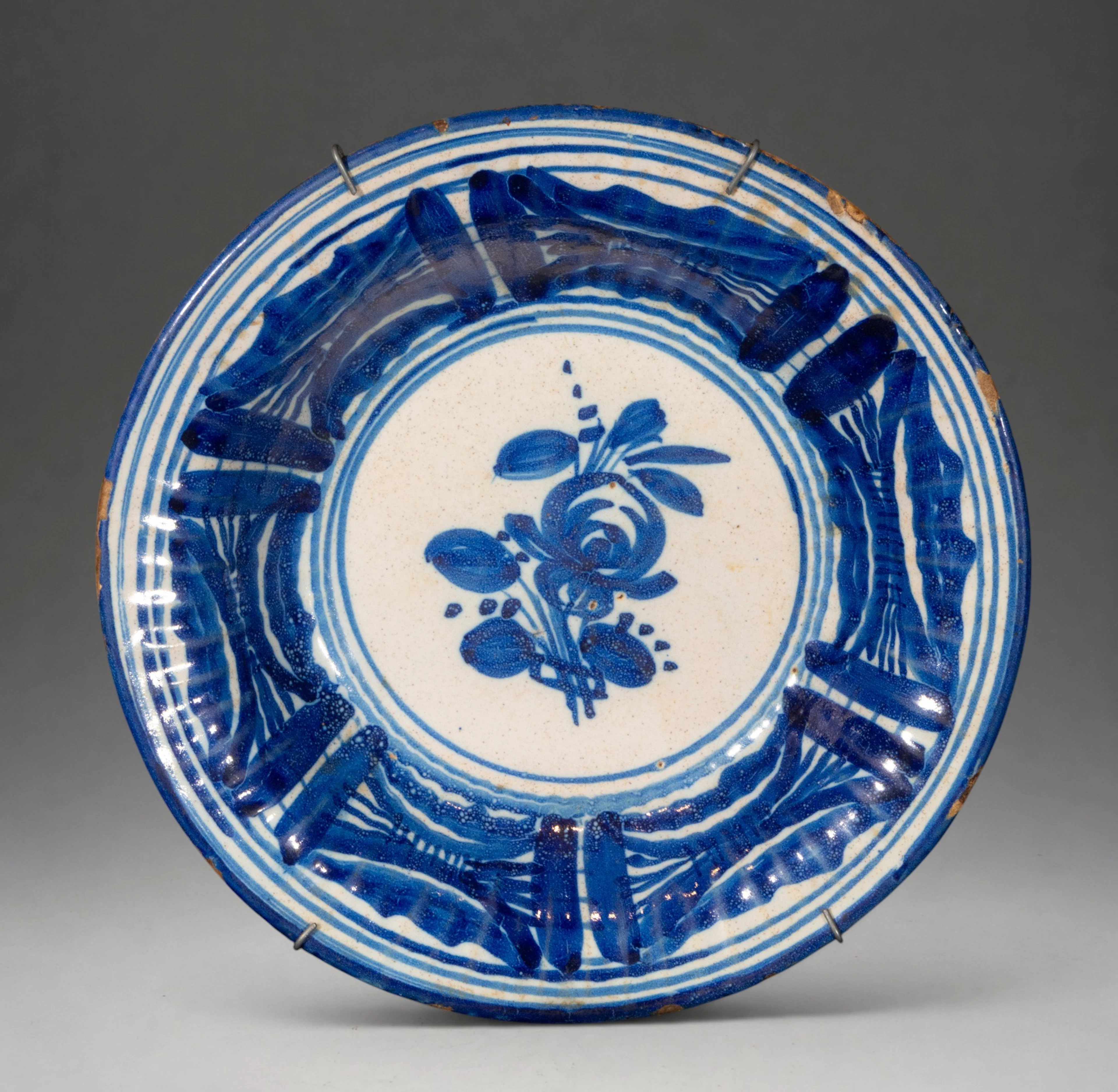 MANISES CERAMICS - Plate with central flower and geometric decoration in blue