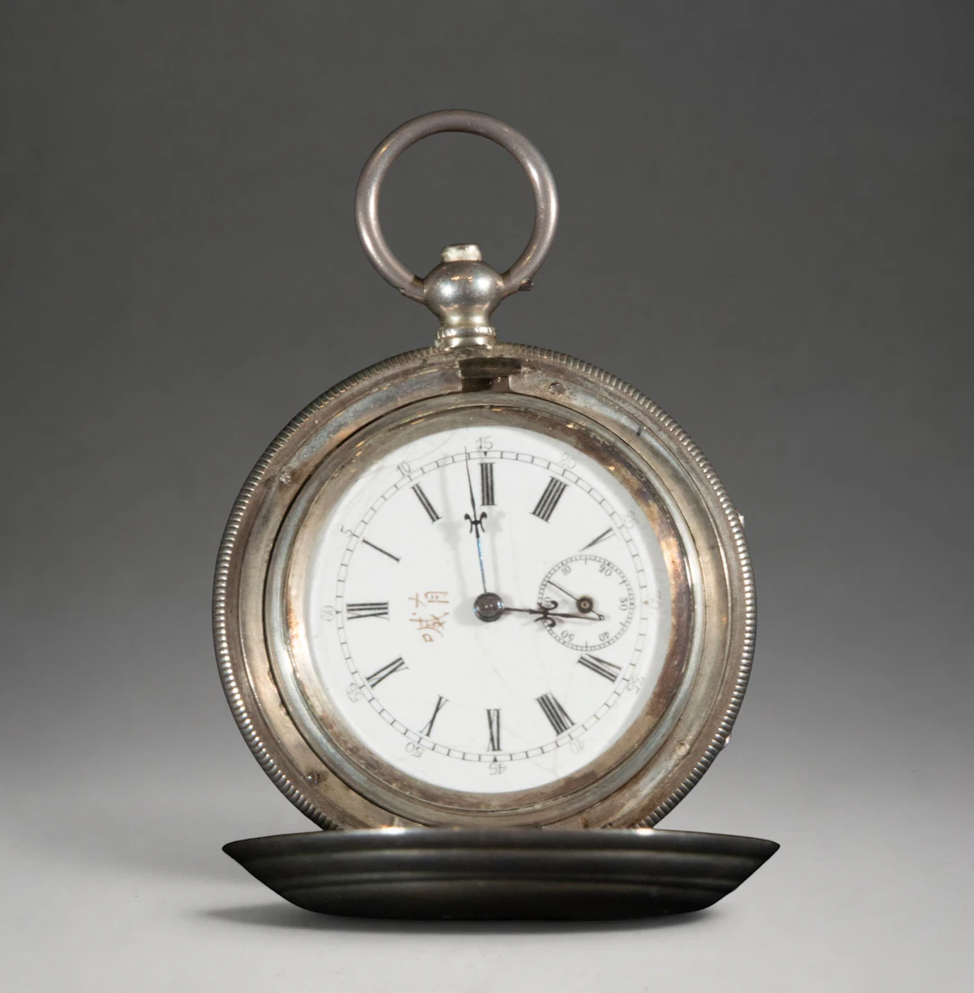 Pocket watch with hinged cover and white dial