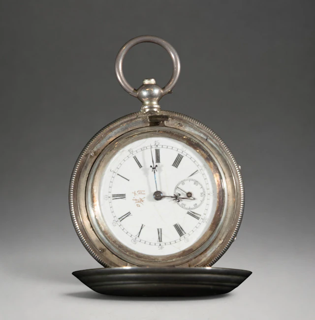 Pocket watch with hinged cover and white dial
