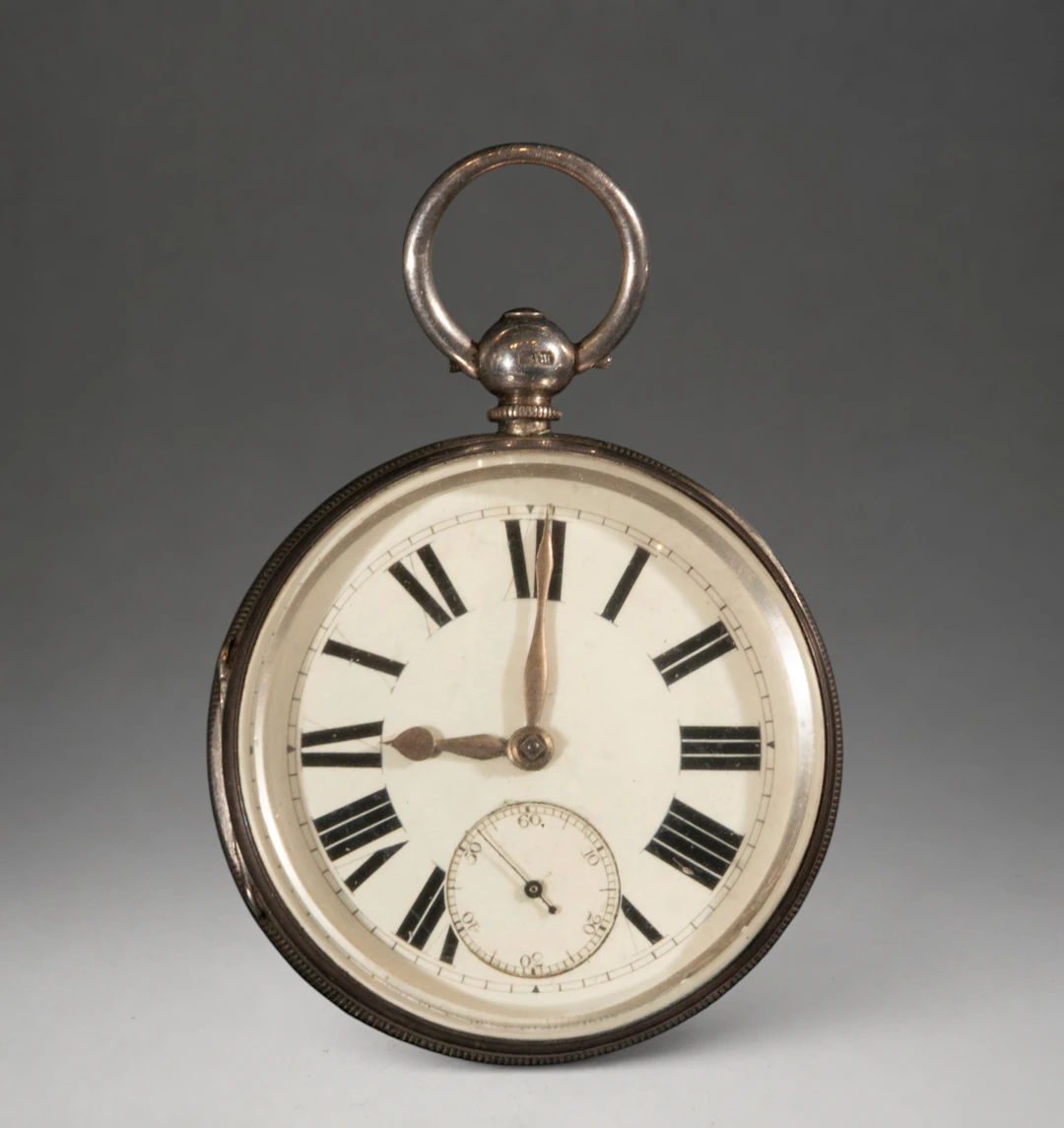 Pocket watch with white dial and Roman numerals
