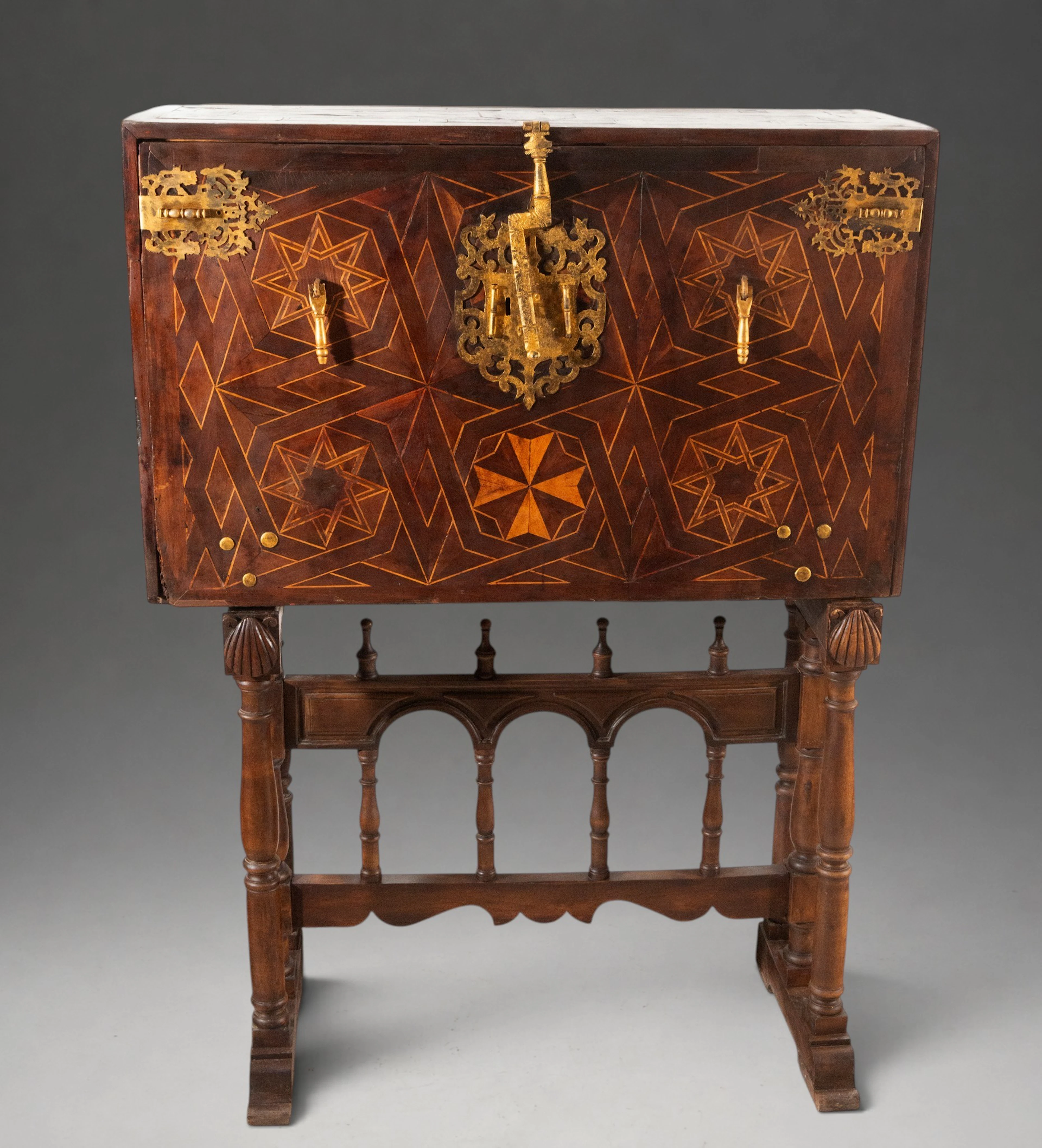 Geometric marquetry bargueño with gilt fittings on a support table
