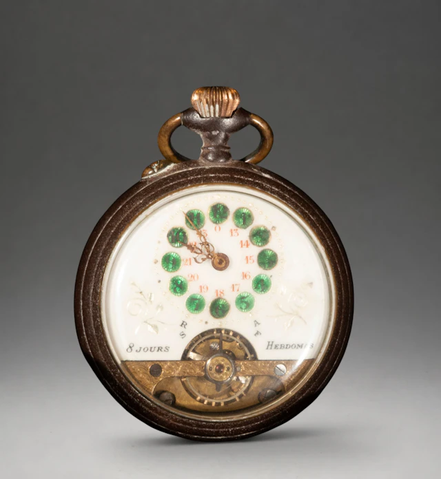 Pocket watch with ornate dial and Roman numerals