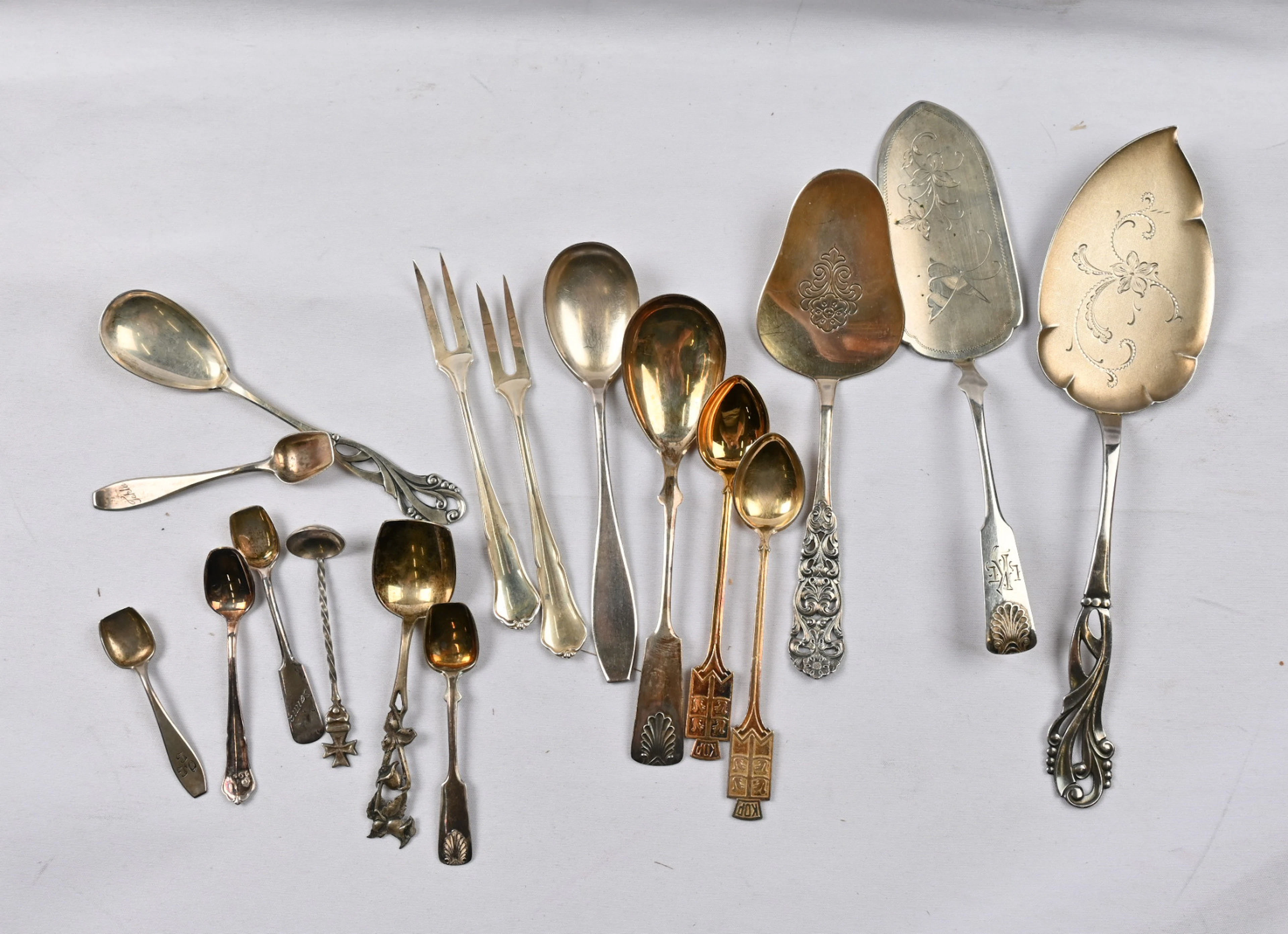 Selection of 17 pieces different cutlery from mini spoons to a cake