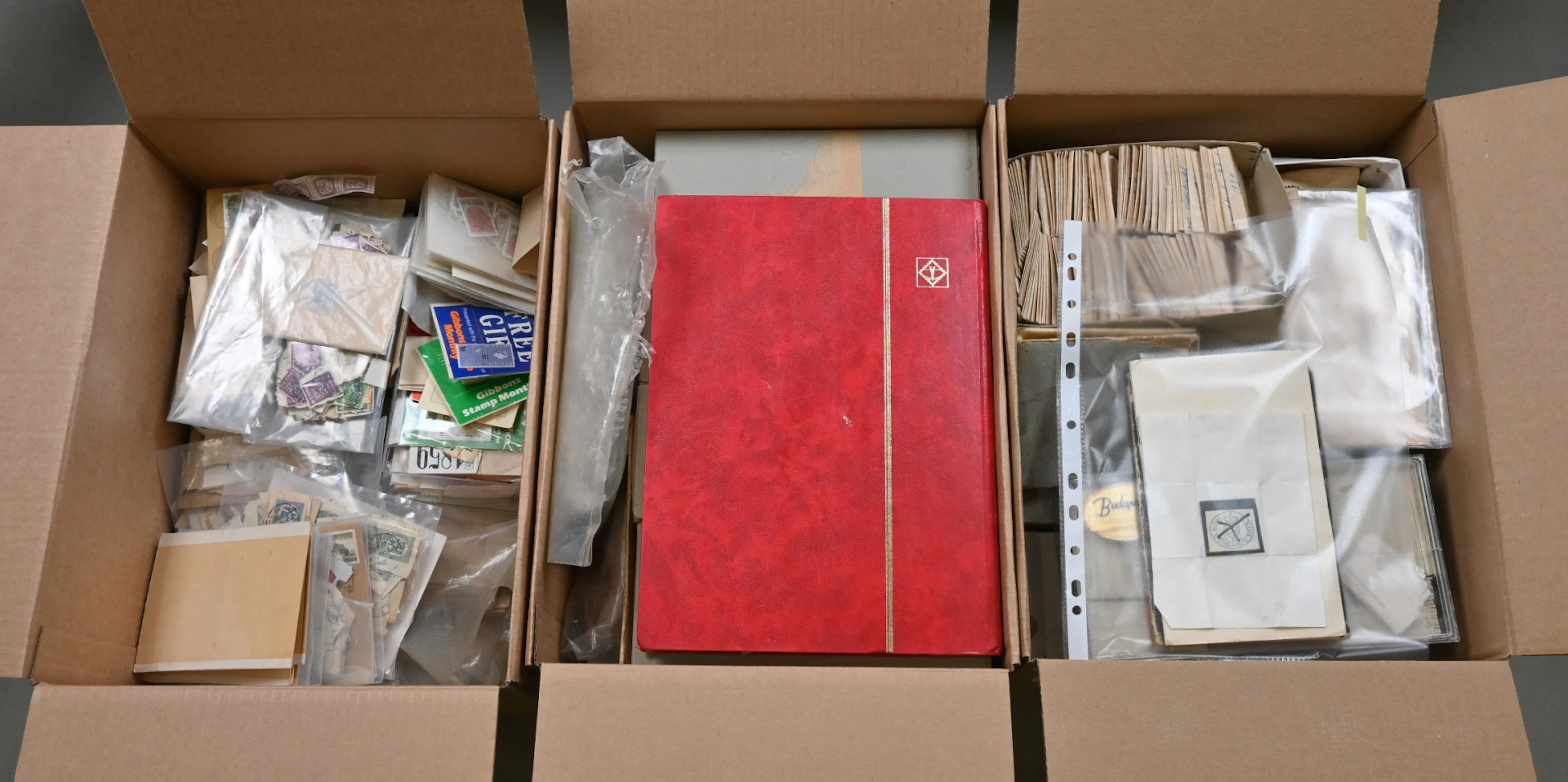 Loose stamps in three bix boxes, gross weight over 15 KG. Plenty of