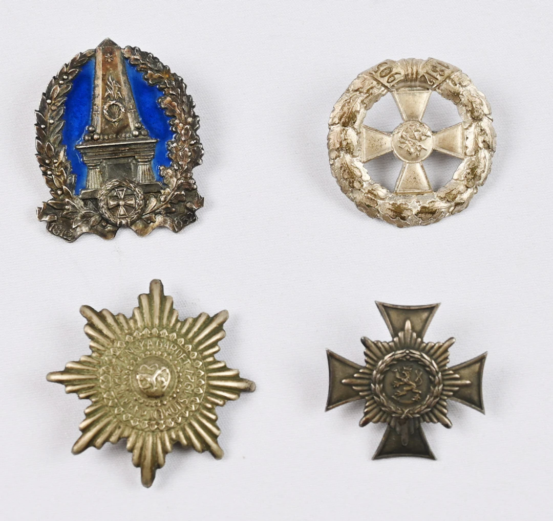 Four rare Finnish Guard (Suomen Kaarti) reunion badges, each representing