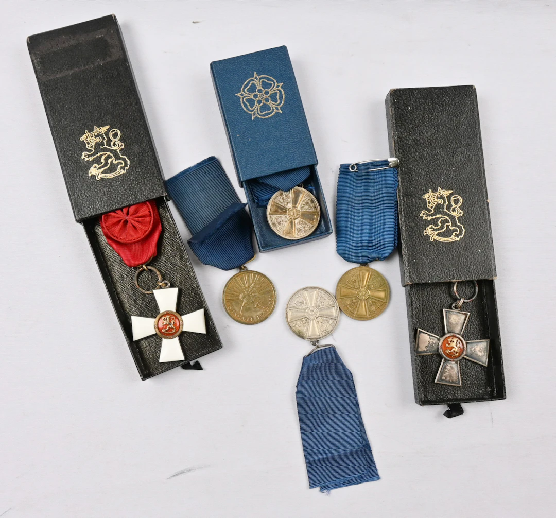 Selection of Finnish merit badges, part in their original boxes. In