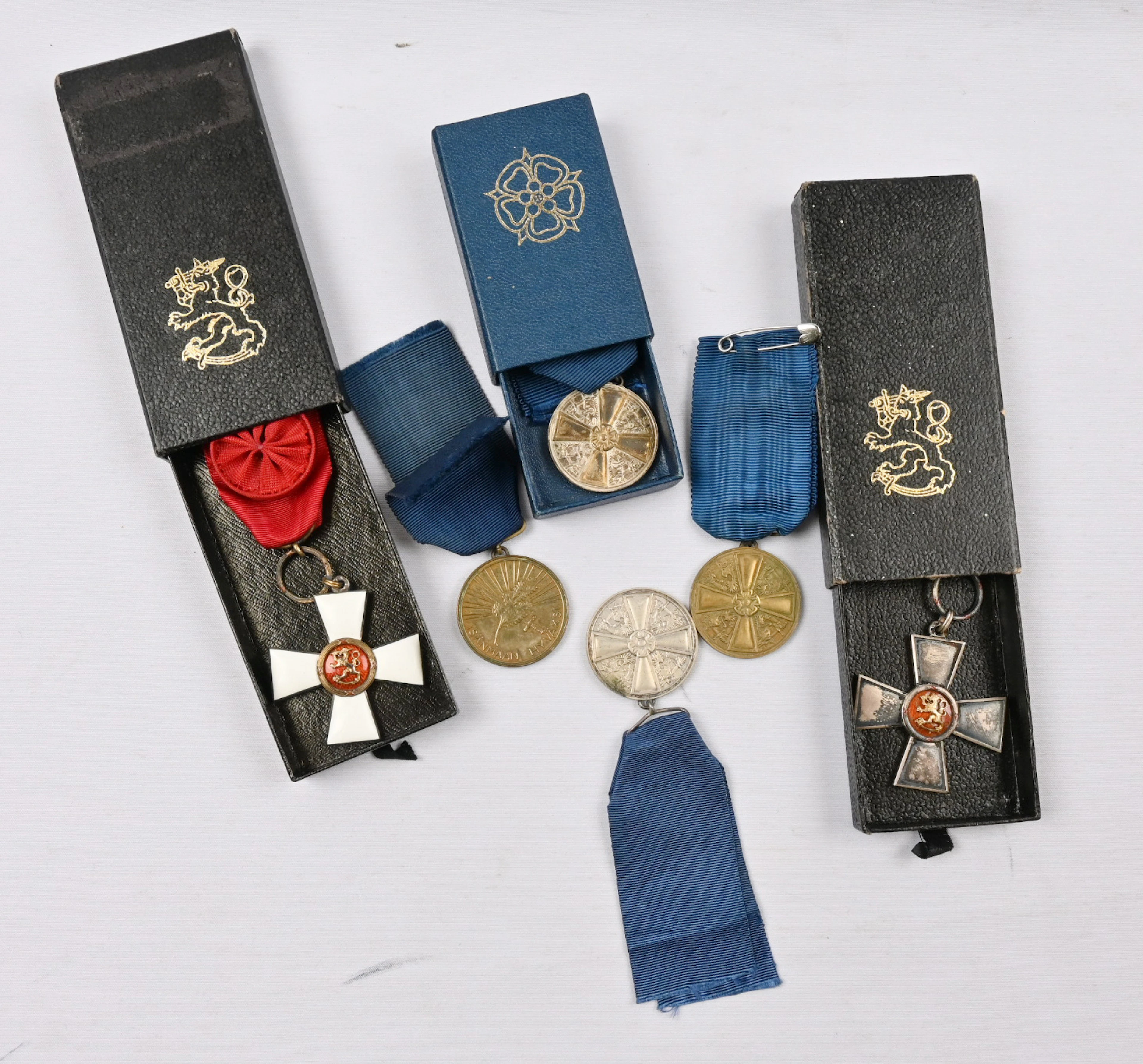 Selection of Finnish merit badges, part in their original boxes. In