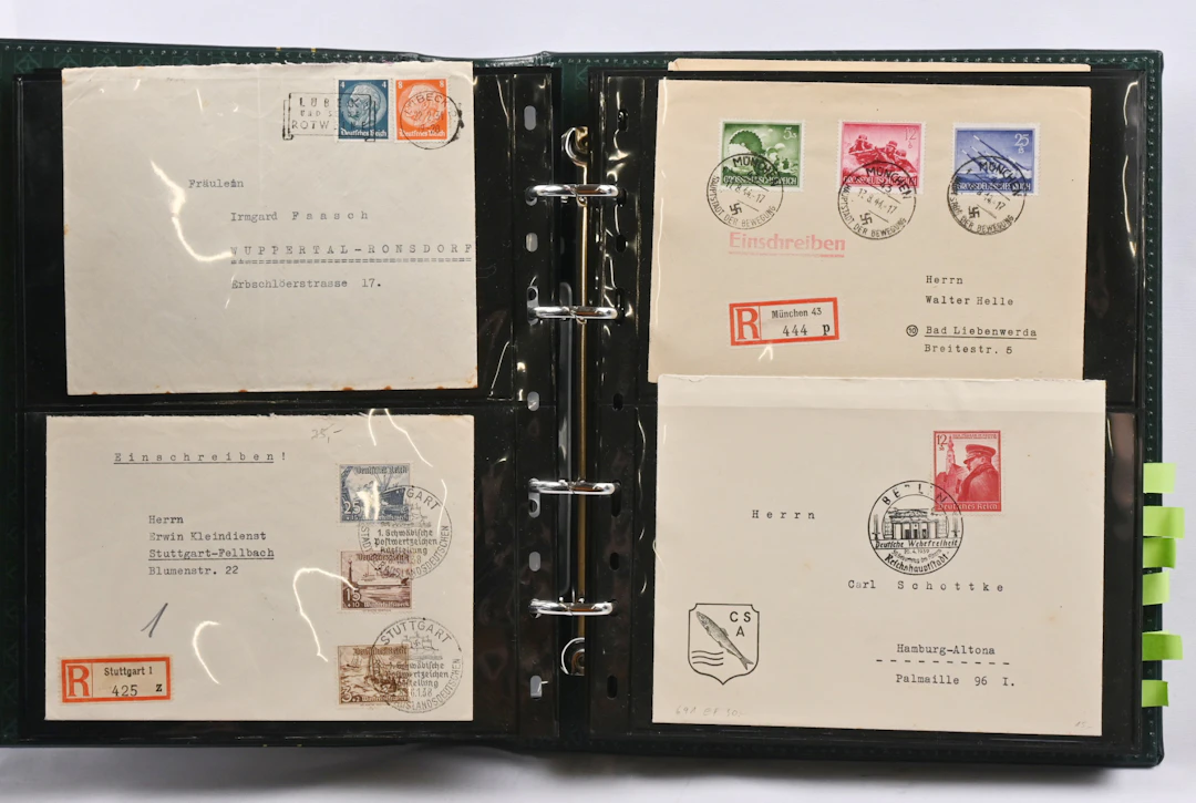 Album mainly of Reich era stamps and postal items. Two Hitler miniature