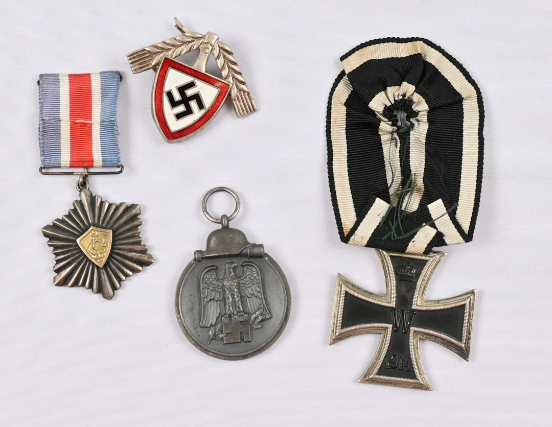 Selection of merit badges, one medal and a German cap badge. On the