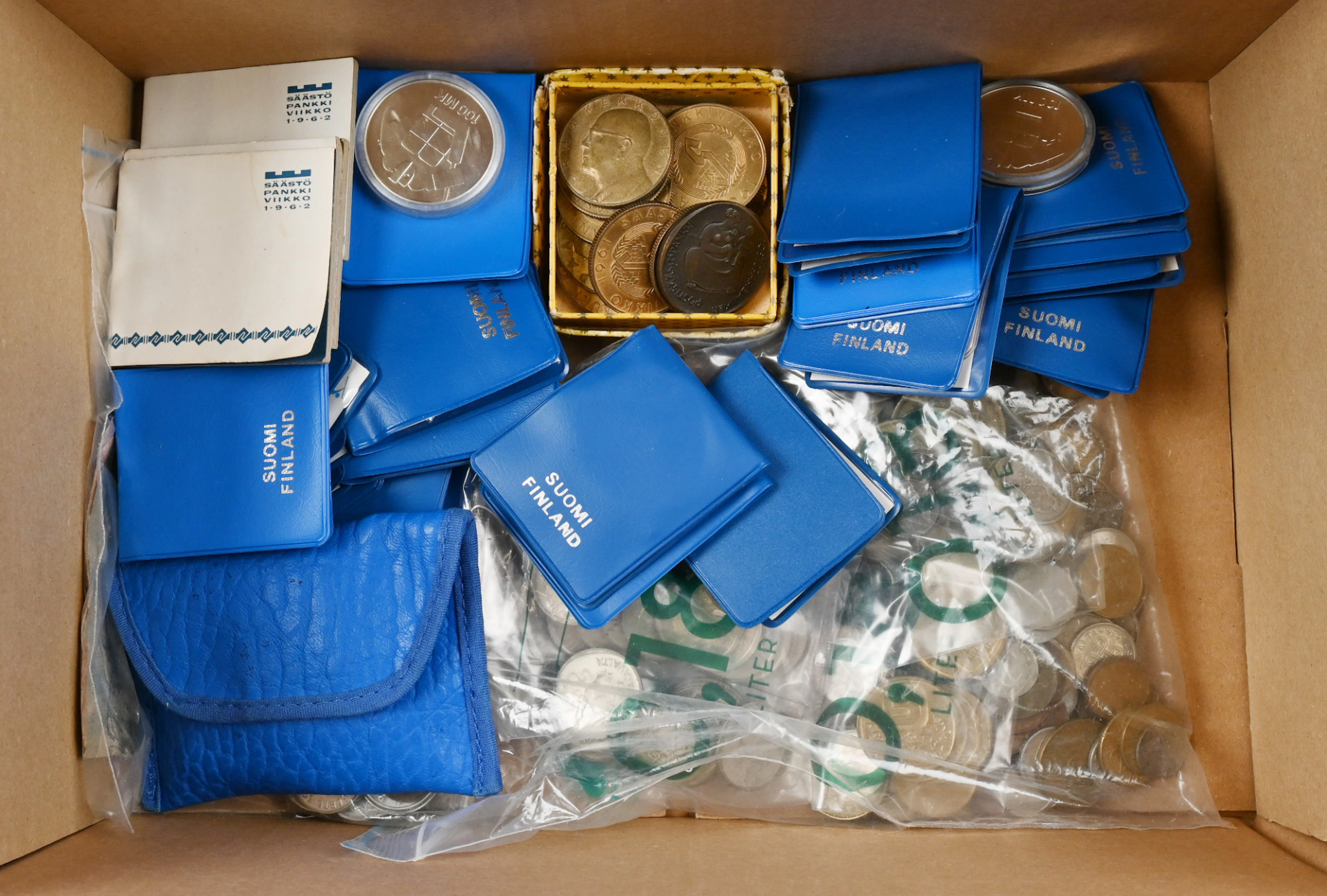 Selection of coins etc. material in a box eg. commemorative coins
