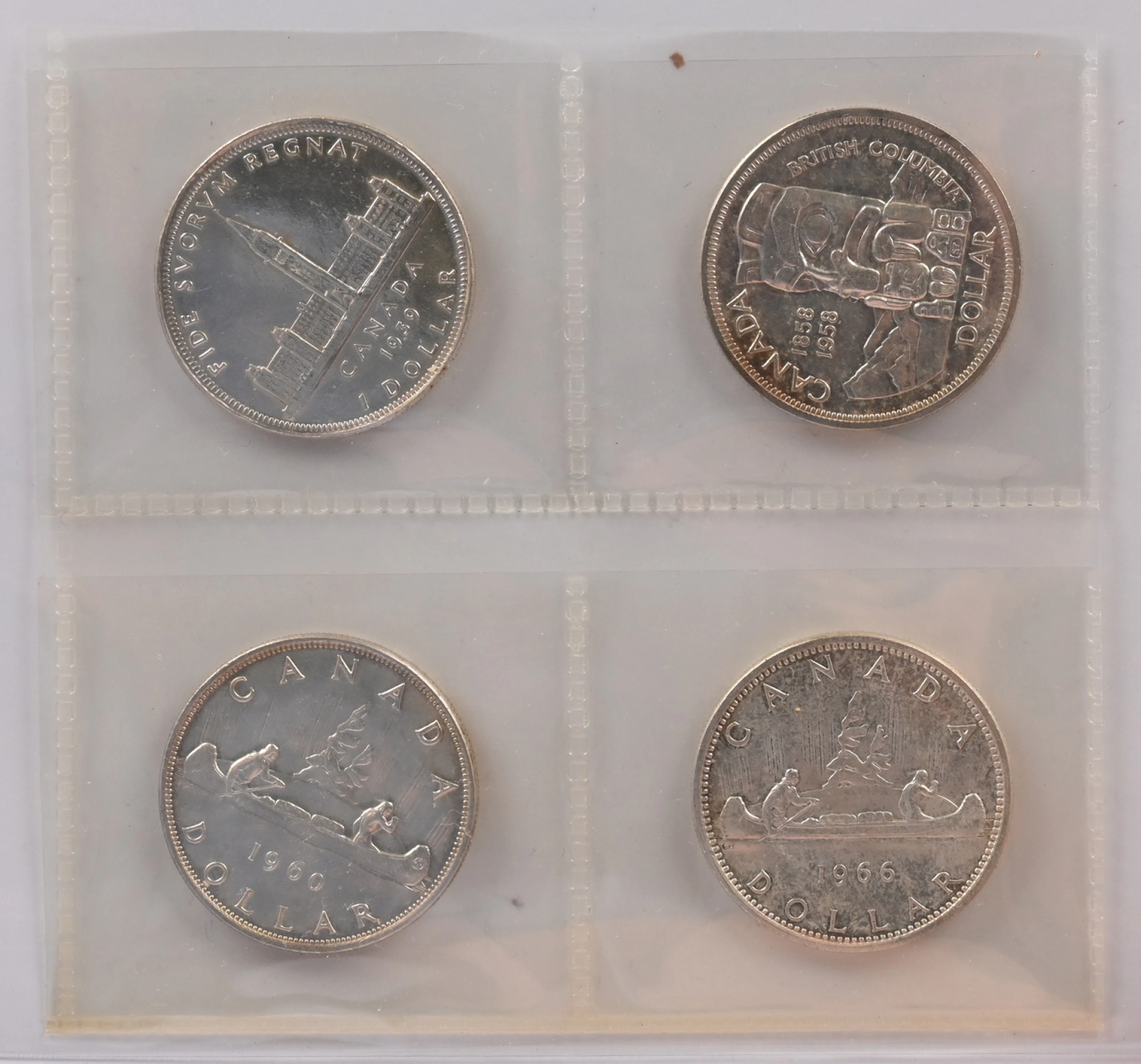 Canada 1938, 1958, 1960 and 1966 silver dollars. Fine condition.