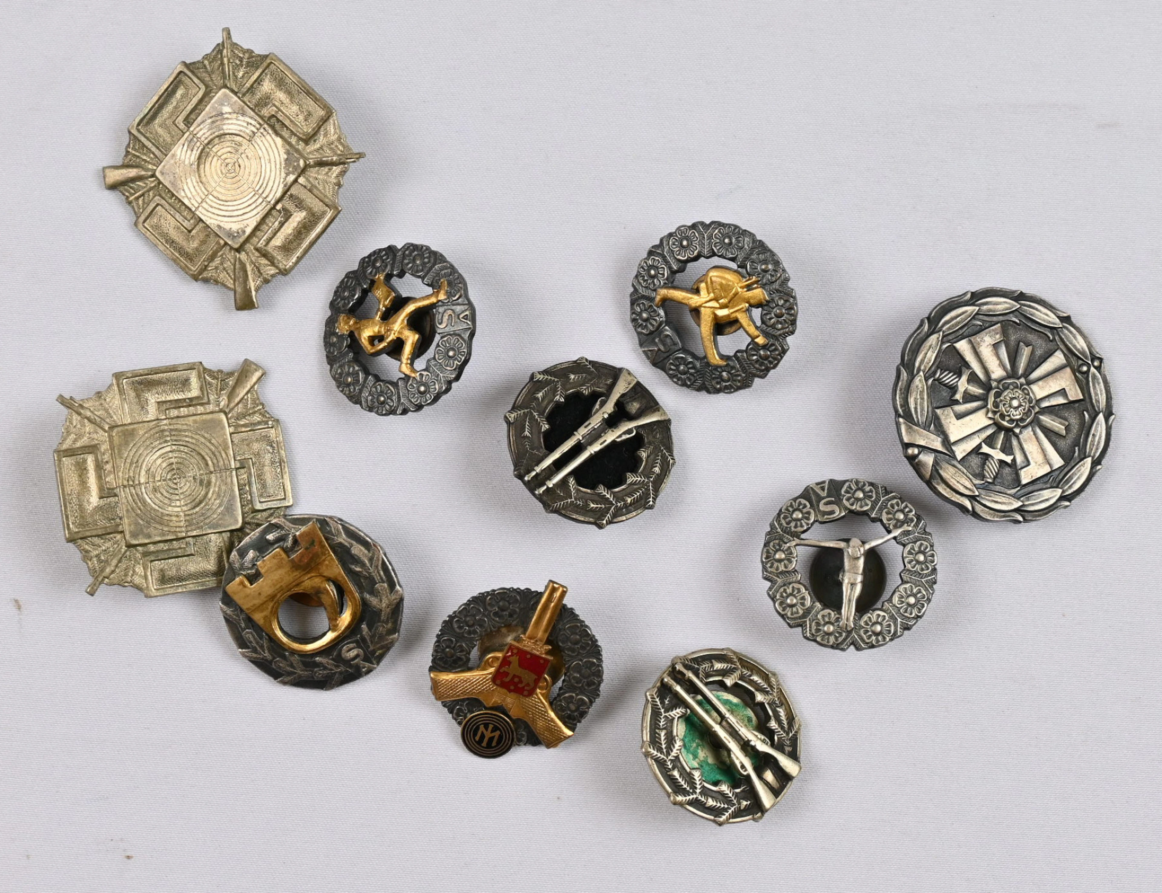 Selection of different shooting and sports badges, as well as a Continuation