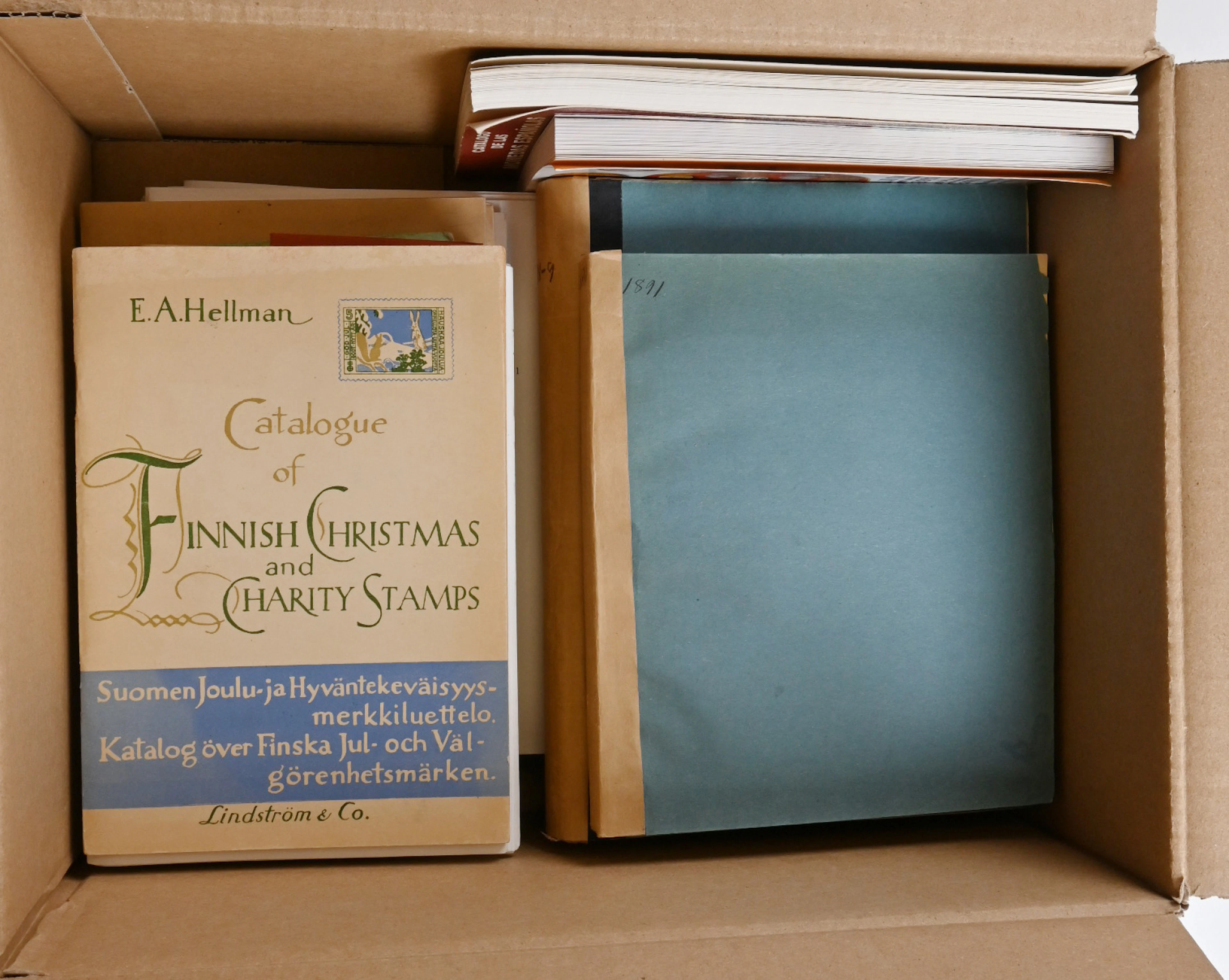 Small box of literature related to philately and other collecting.
