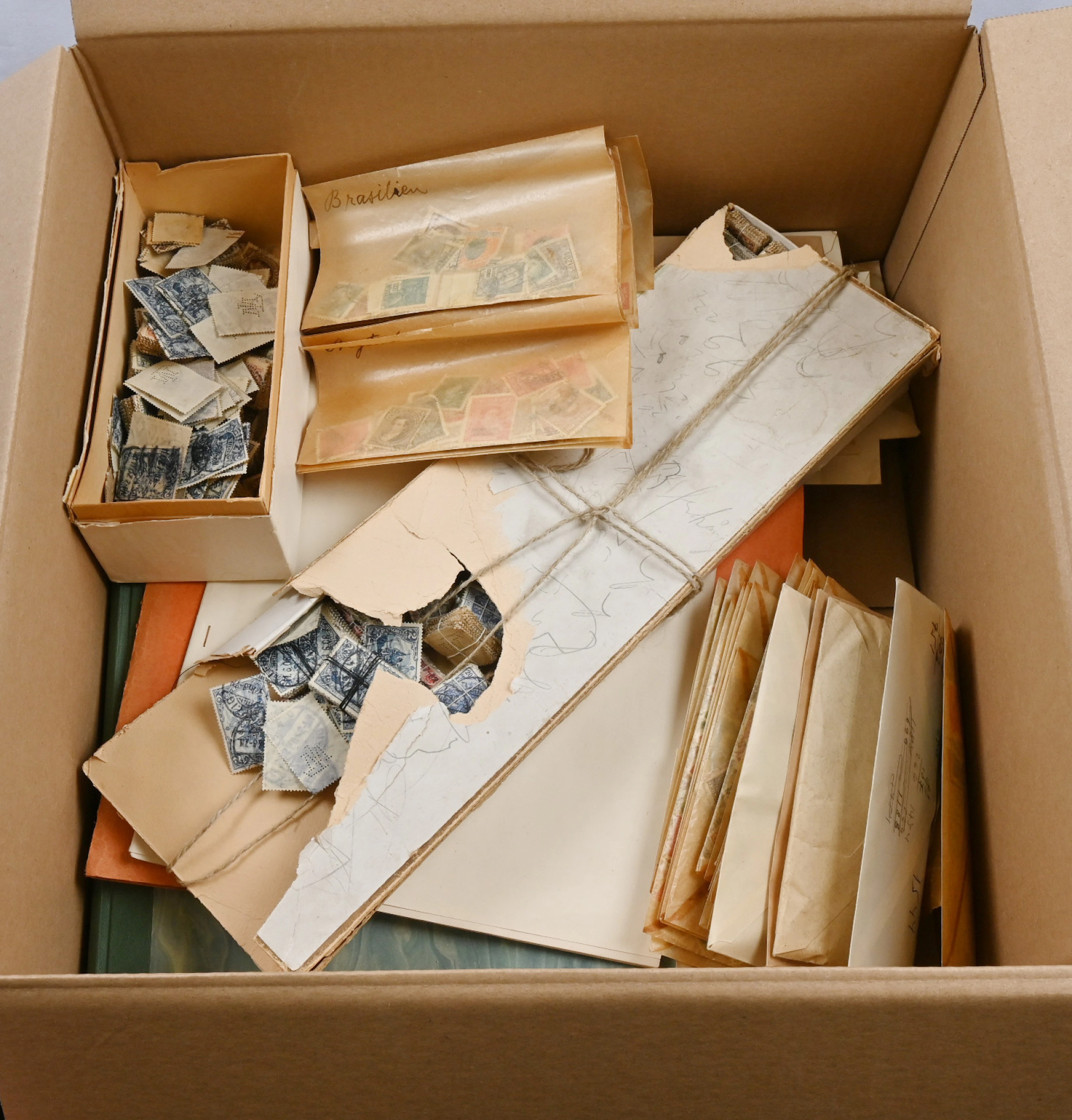 Interesting old material in a ca. 4 KG box. A few stockbooks, stamps