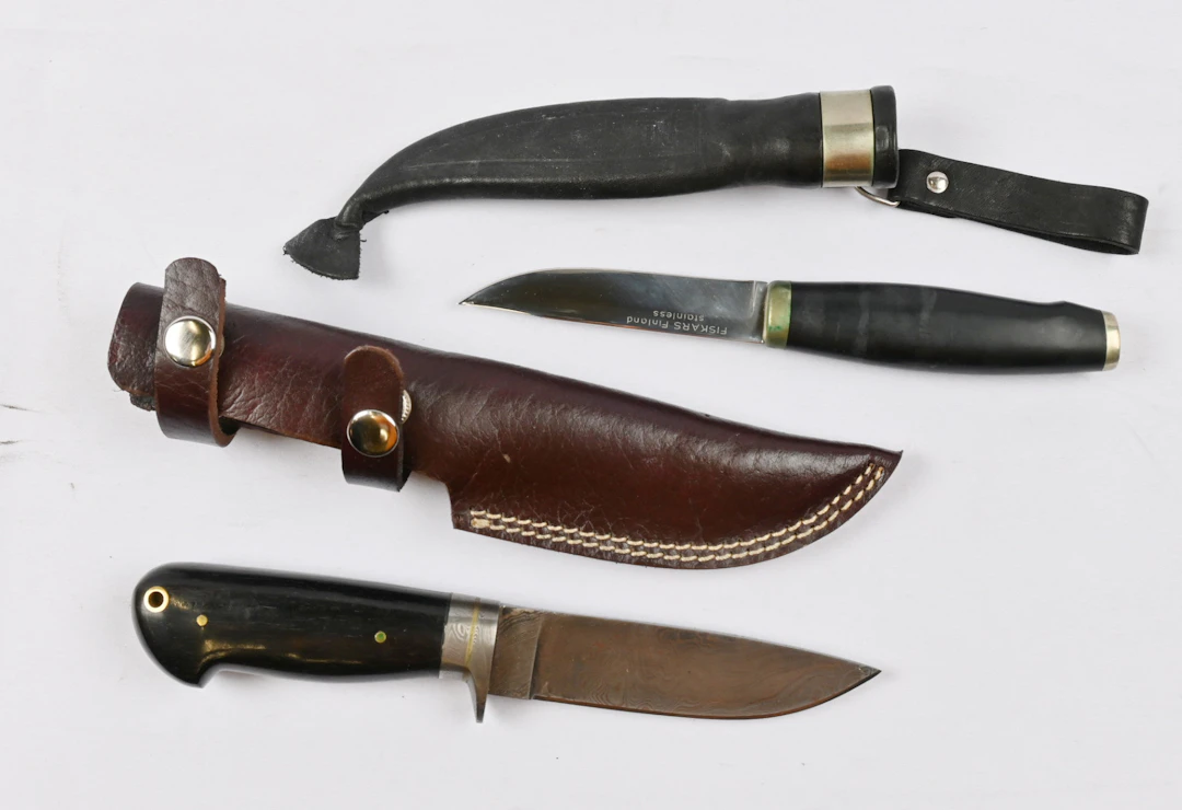 Two knives, one of which is a so-called Fiskars knife and the other