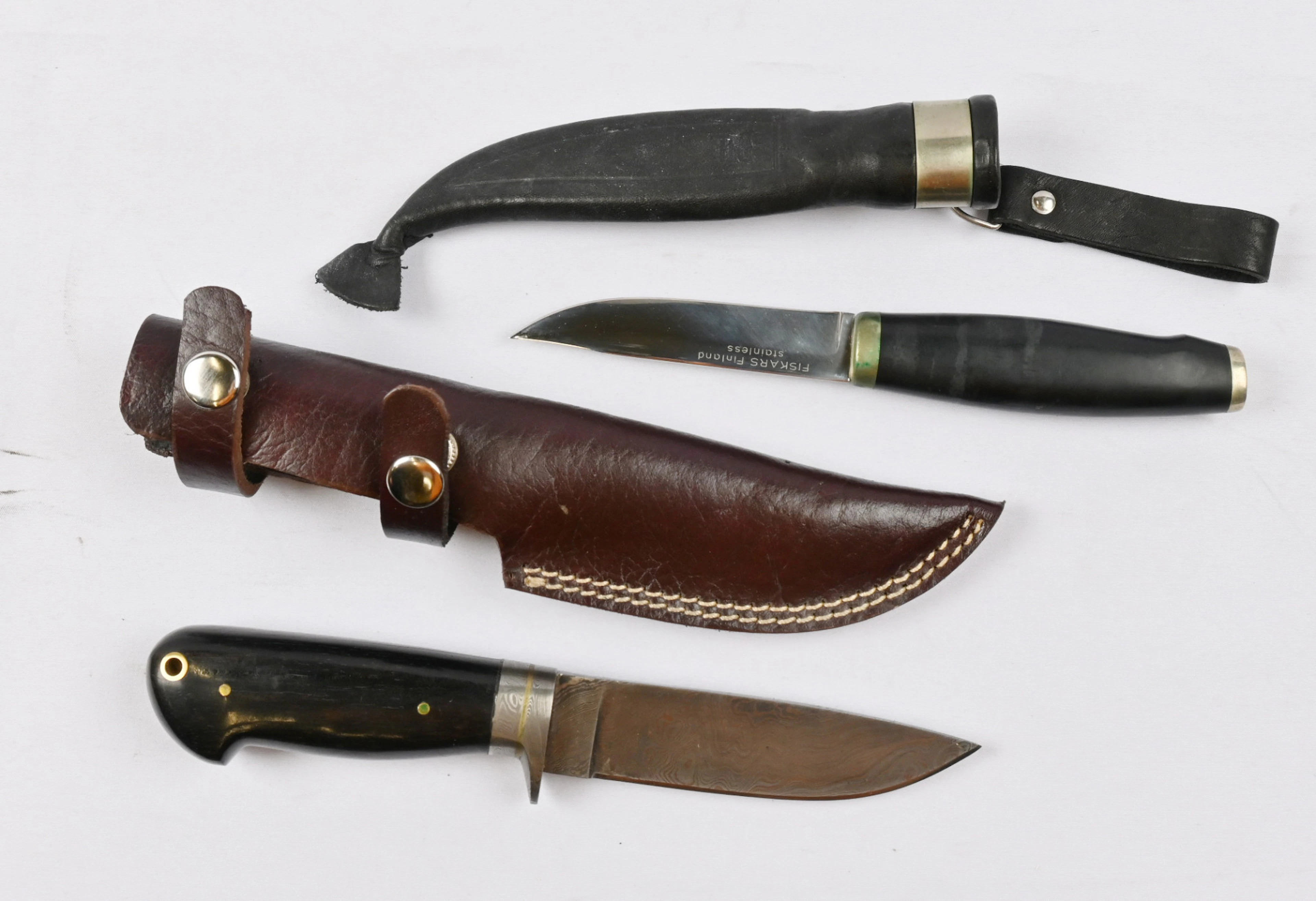 Two knives, one of which is a so-called Fiskars knife and the other