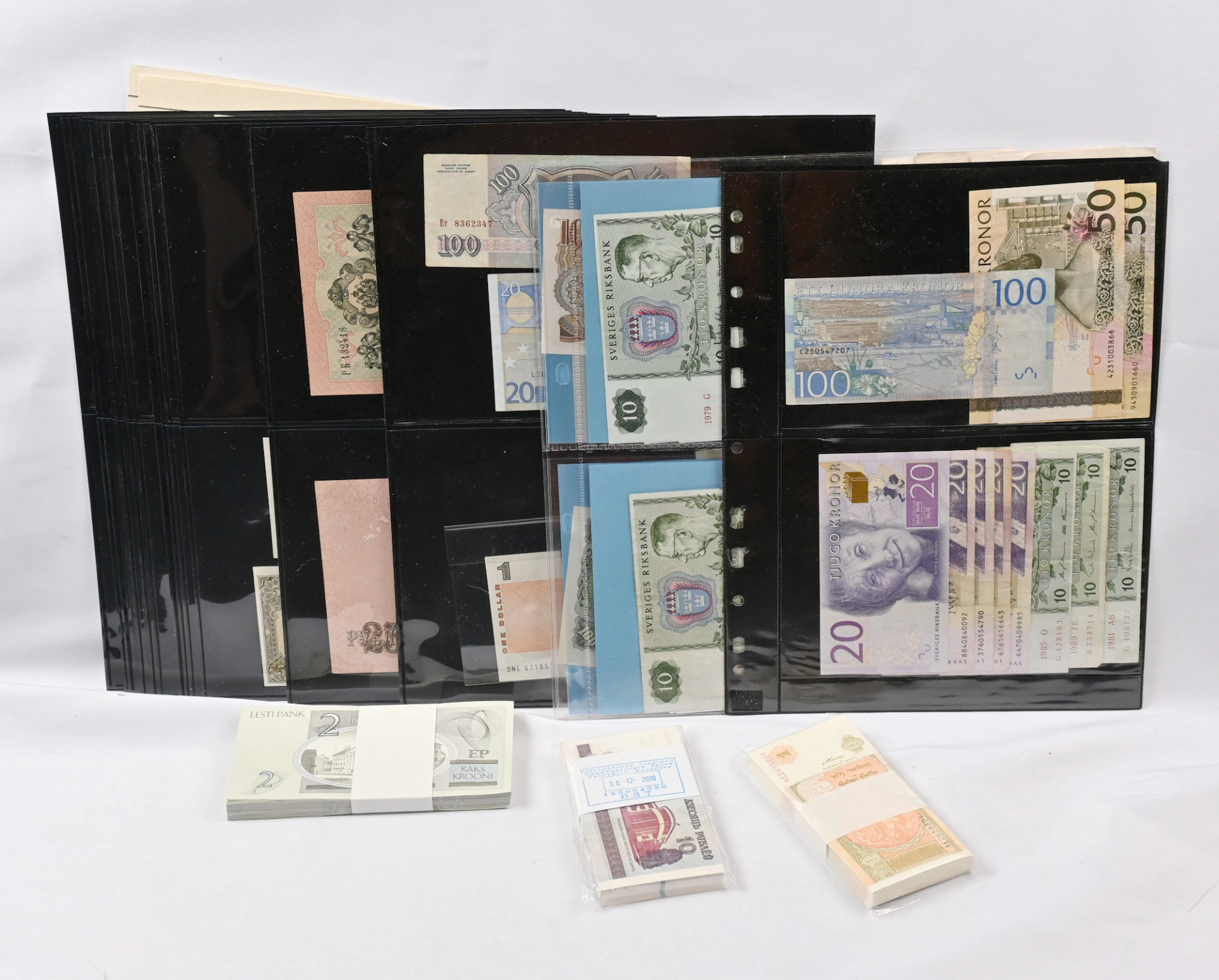 Worldwide banknotes on pages and in bundles, also fantasy banknotes