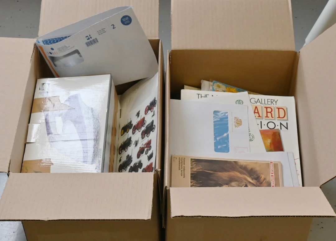 In two boxes an interesting selection of all sorts of paper collectibles.