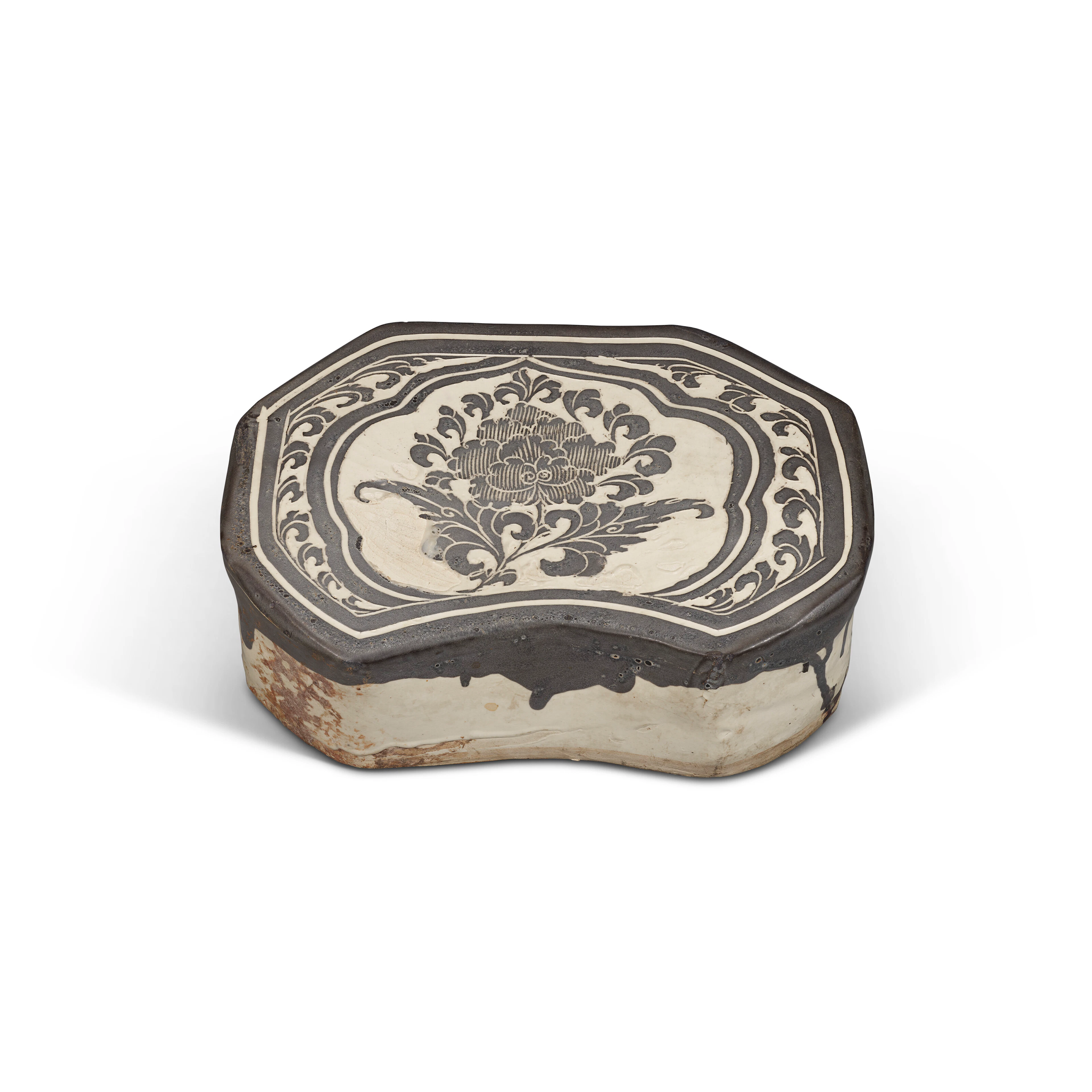 A CIZHOU CARVED 'PEONY' PILLOW