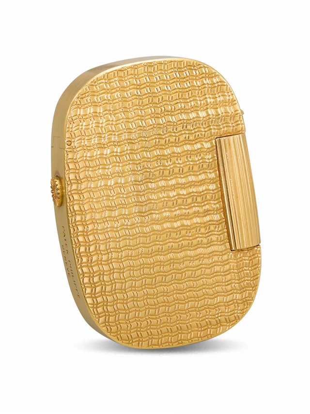 Patek Philippe. A Rare and Attractive 18K Gold Lighter with 'Ocean'