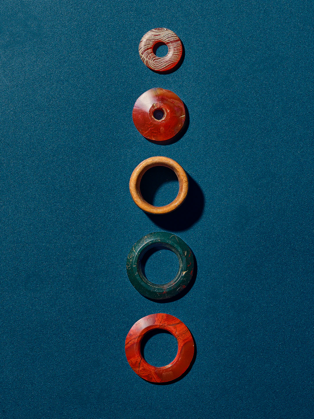A Group of Three Agate Rings, a Hardstone Ring, and a Bone Ring