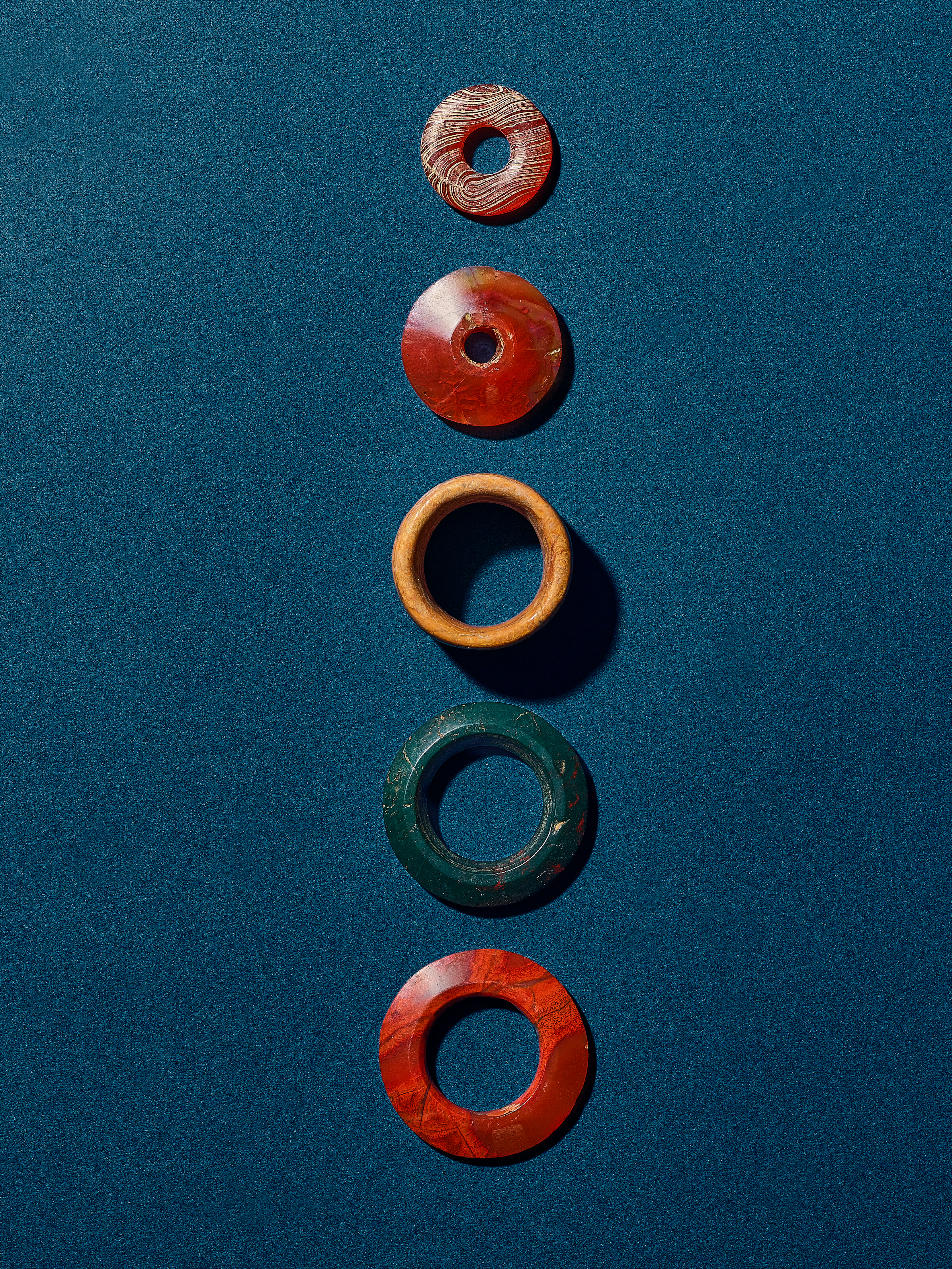 A Group of Three Agate Rings, a Hardstone Ring, and a Bone Ring