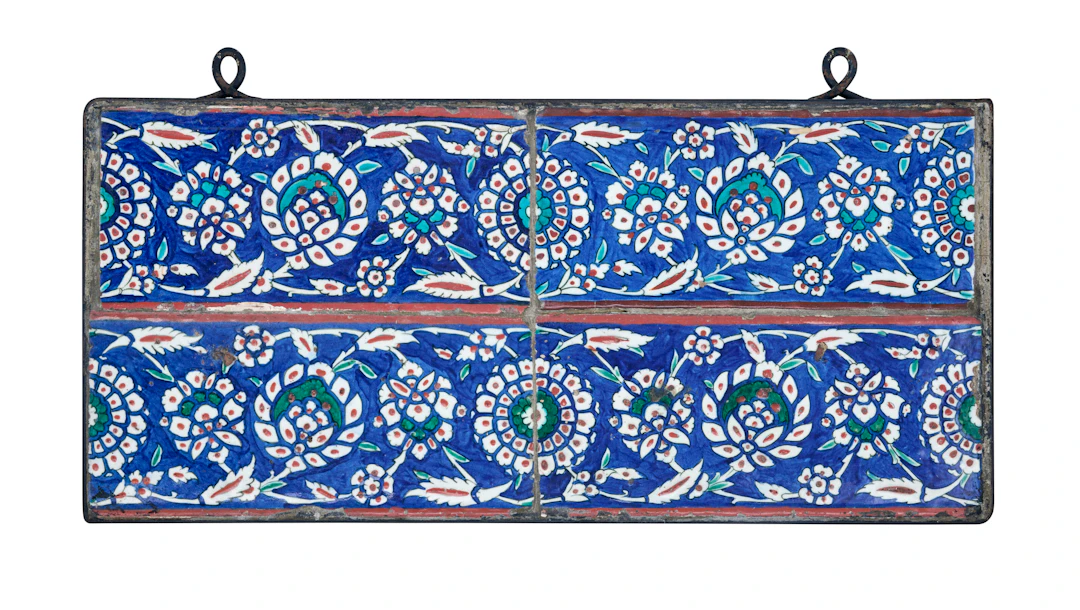 A Panel of Four Iznik Pottery Border Tiles