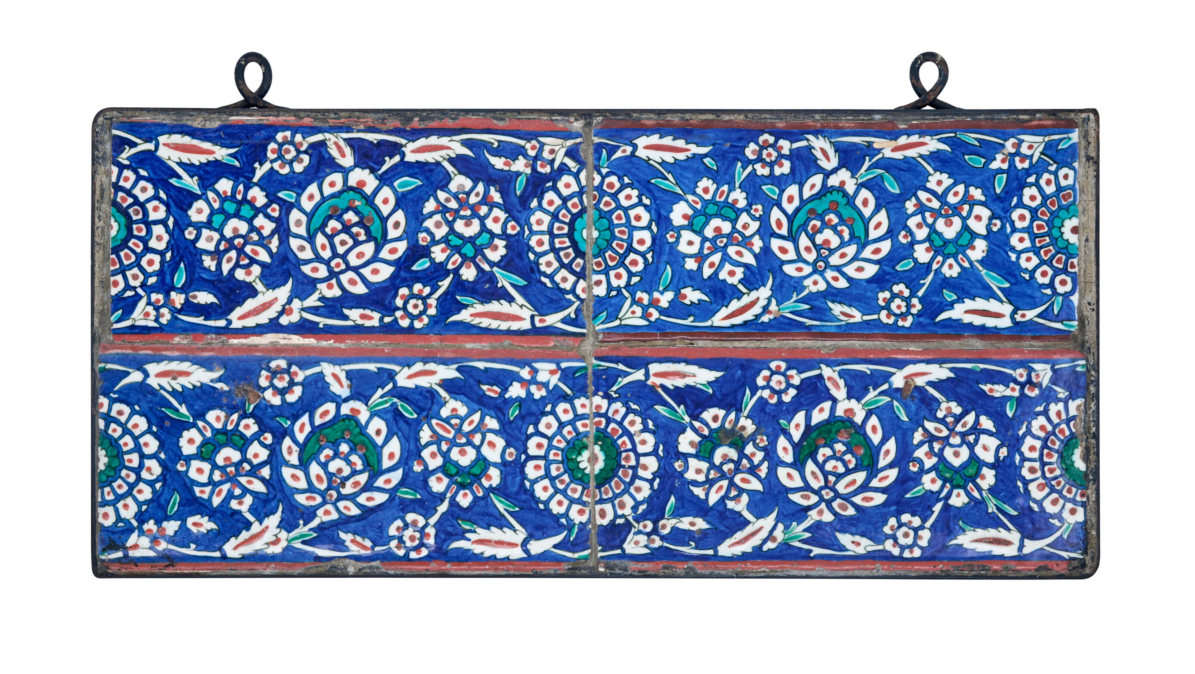 A Panel of Four Iznik Pottery Border Tiles