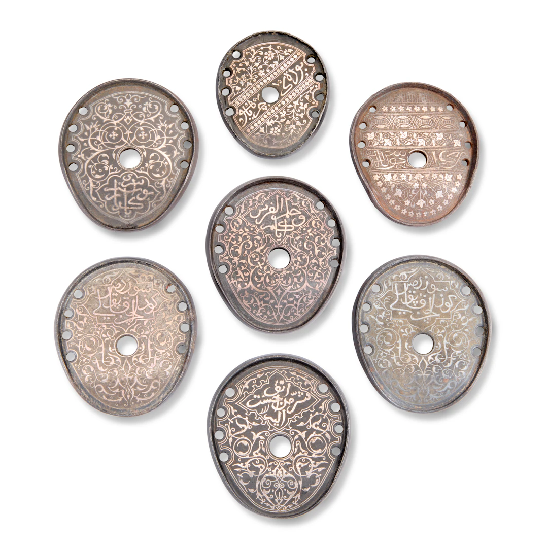 A Group of Seven Silver-Overlaid Iron Horseshoes