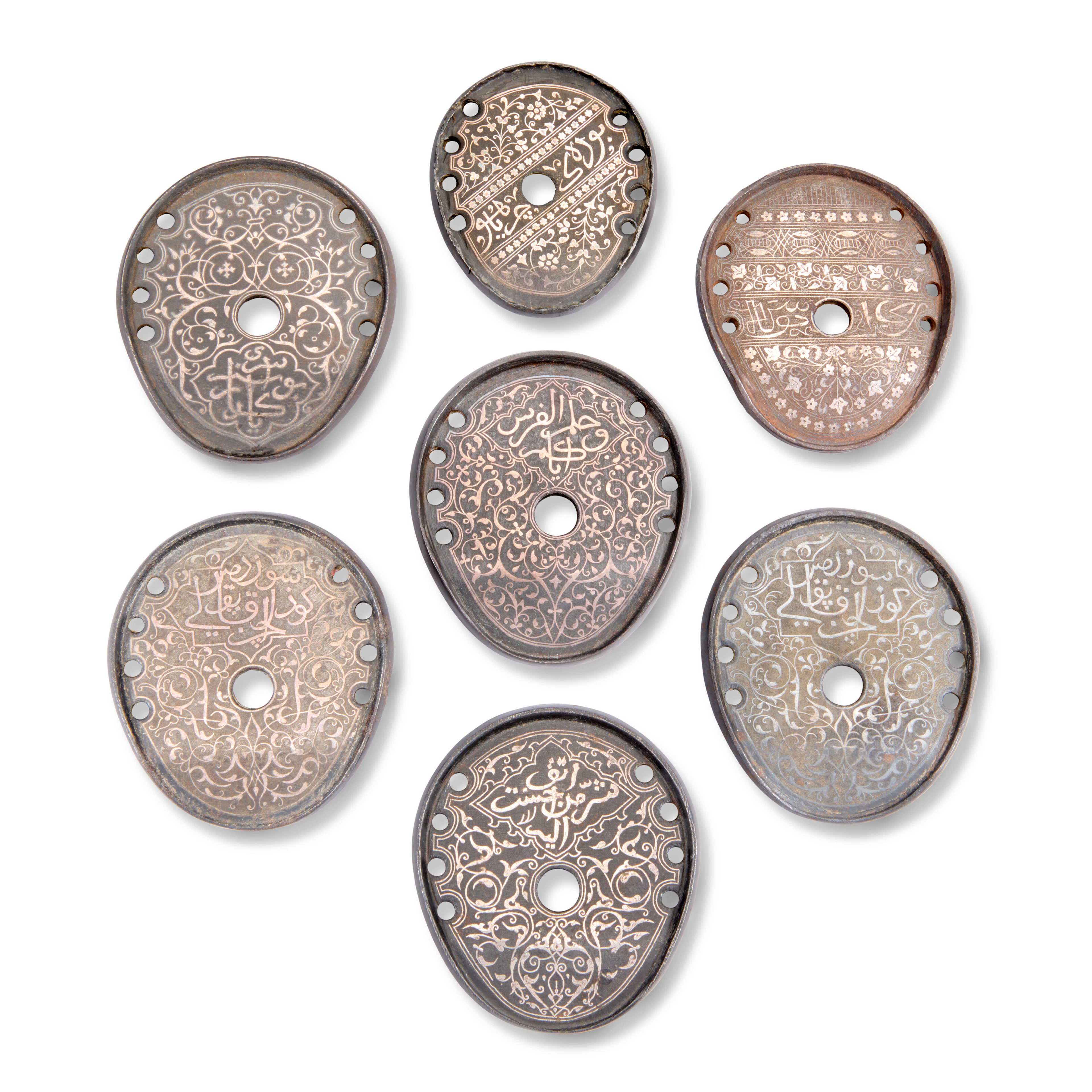 A Group of Seven Silver-Overlaid Iron Horseshoes
