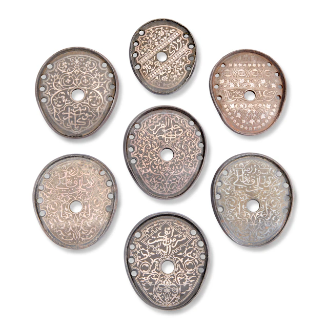 A Group of Seven Silver-Overlaid Iron Horseshoes