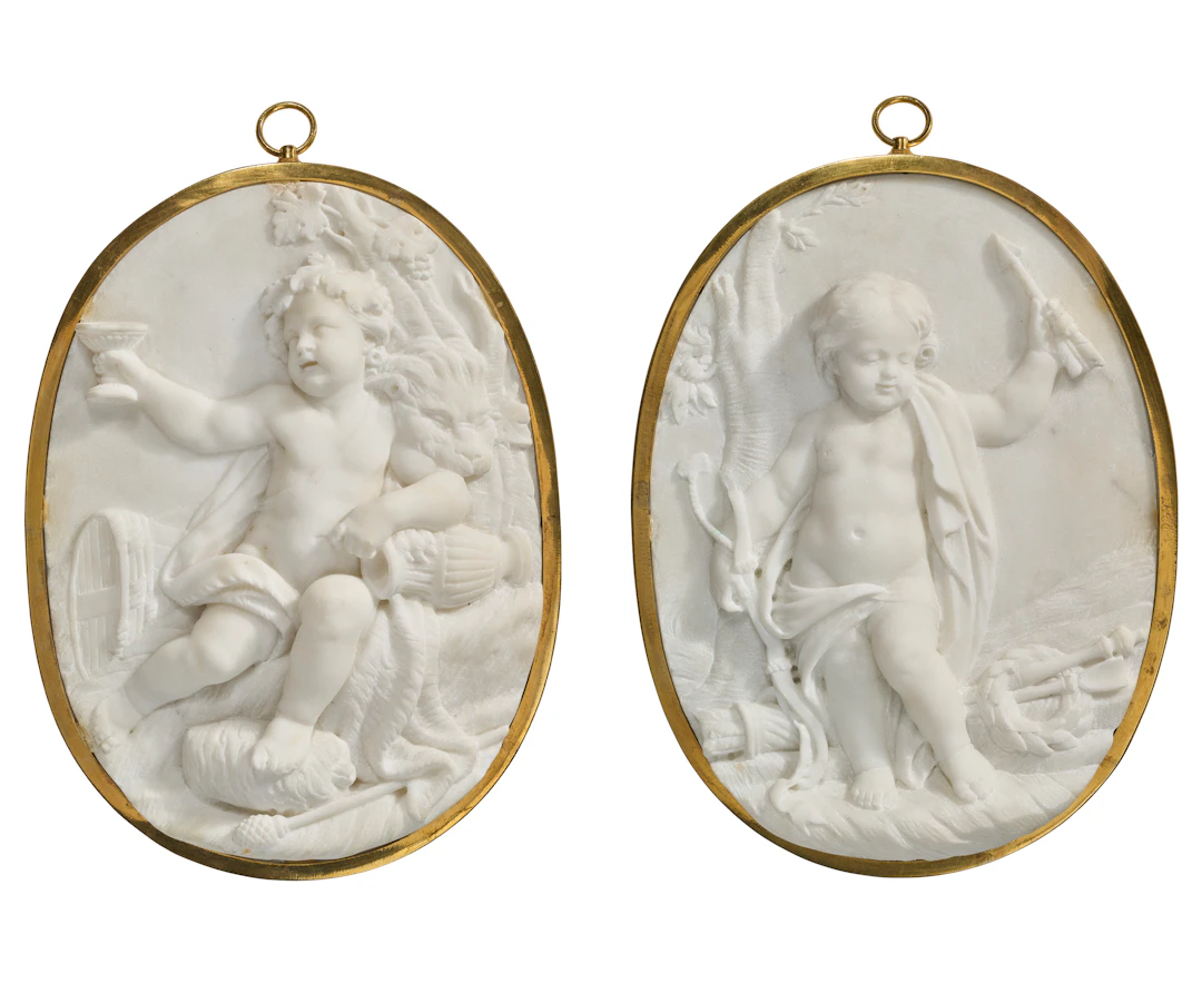 A Pair of French White Marble Medallions, One Depicting a Scene of
