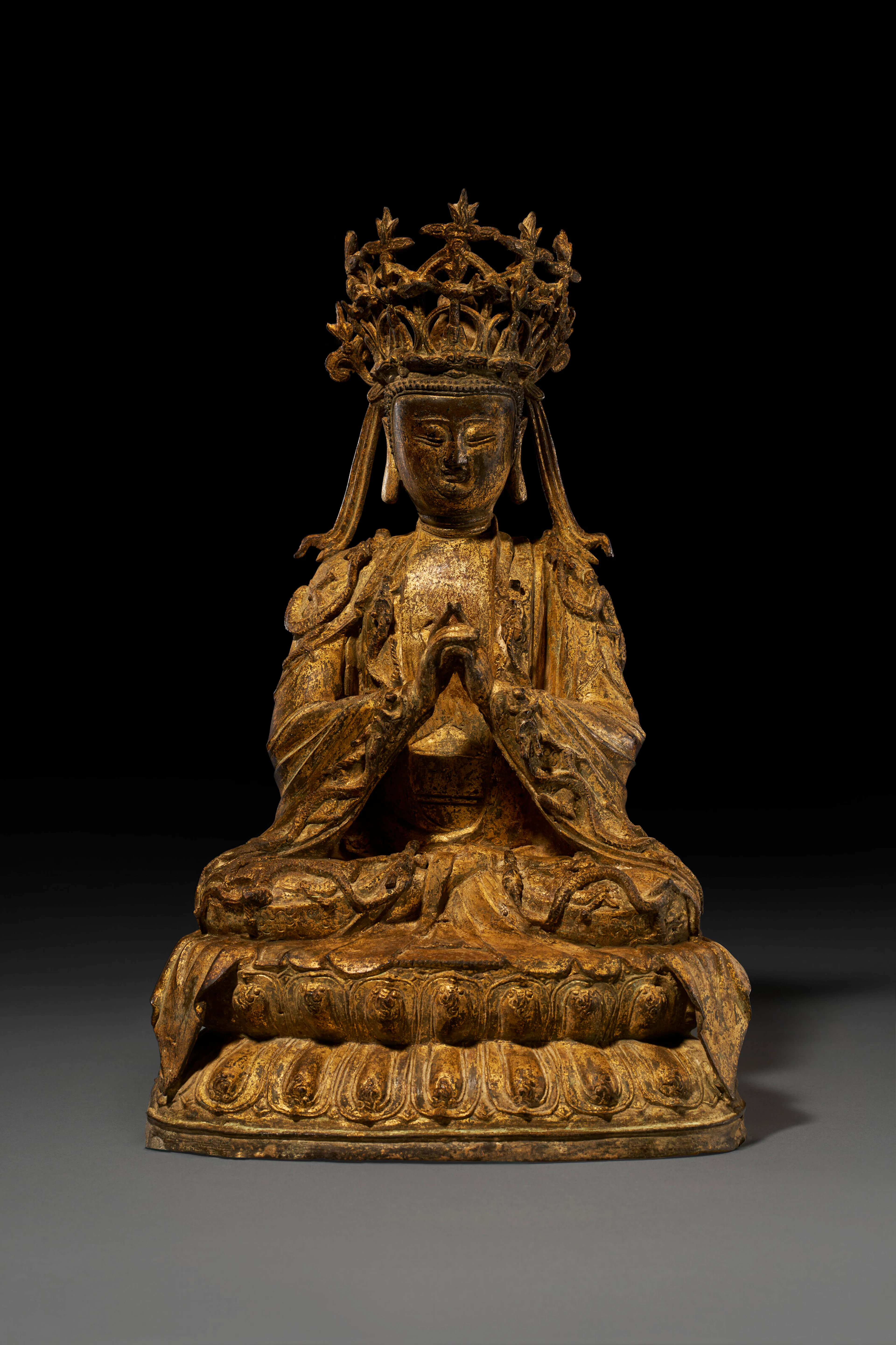 A GILT-LACQUERED-BRONZE FIGURE OF A SEATED GUANYIN