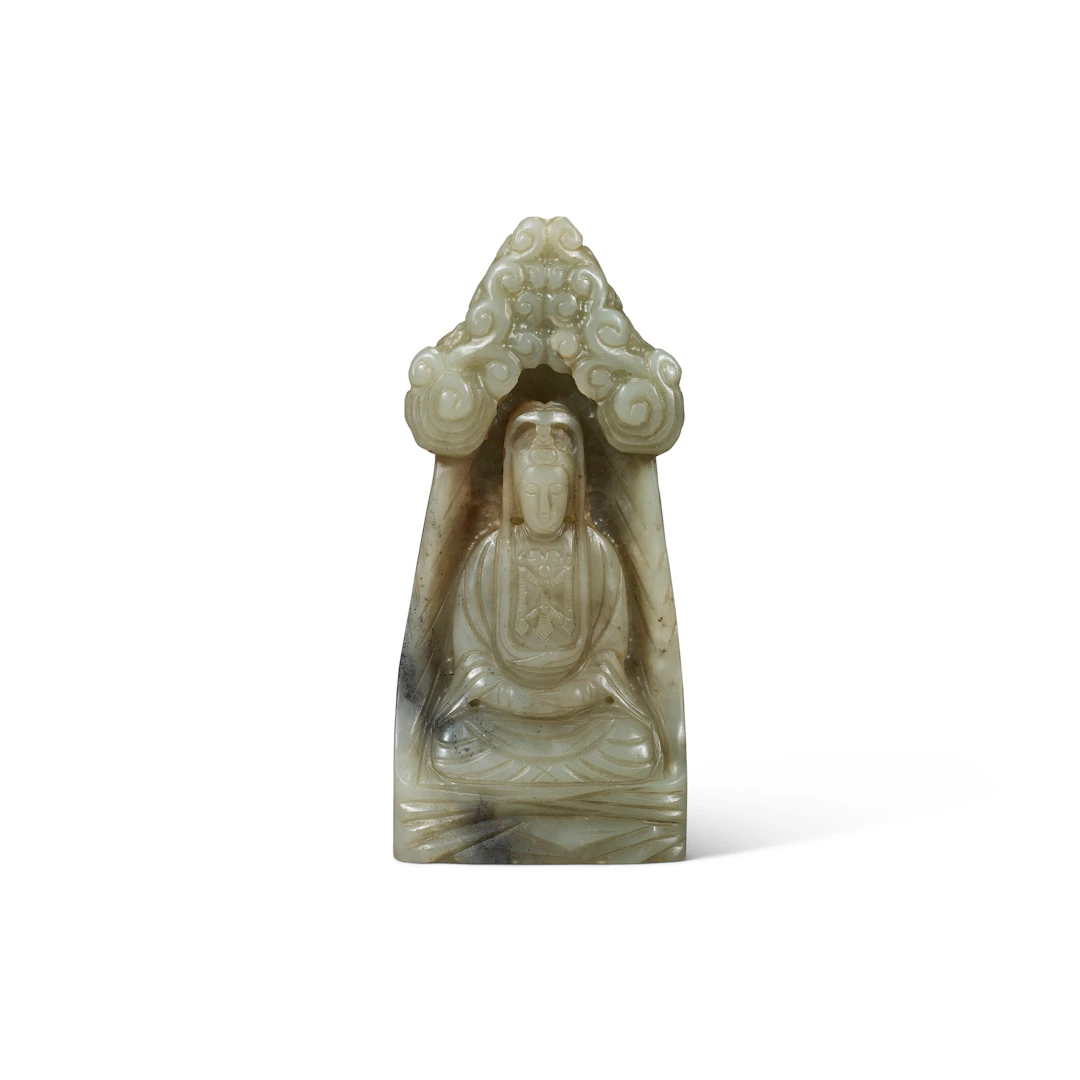 A Rare Celadon Jade Figure of Seated Guanyin in a Grotto
