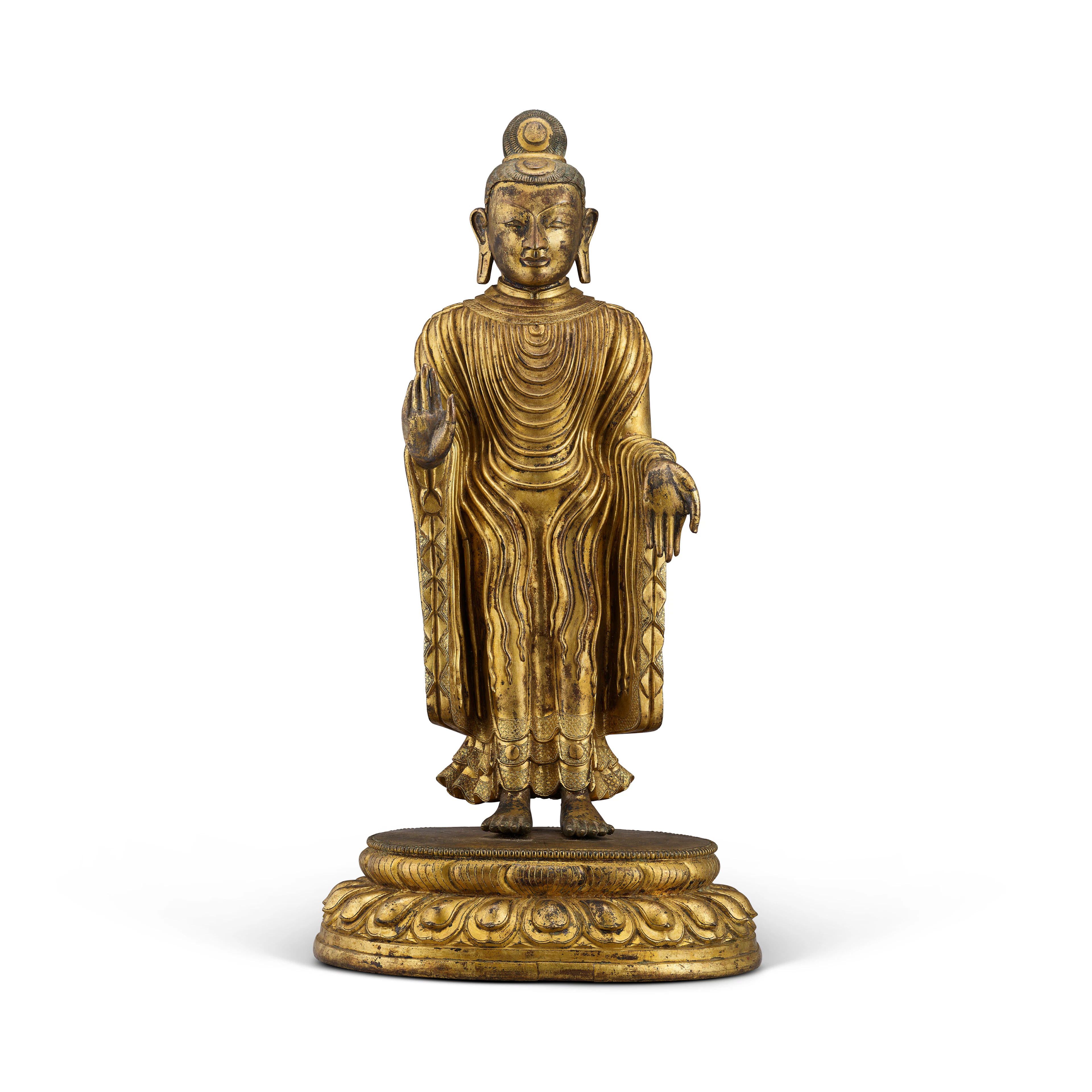 A GILT-BRONZE STANDING FIGURE OF BUDDHA SAKYAMUNI