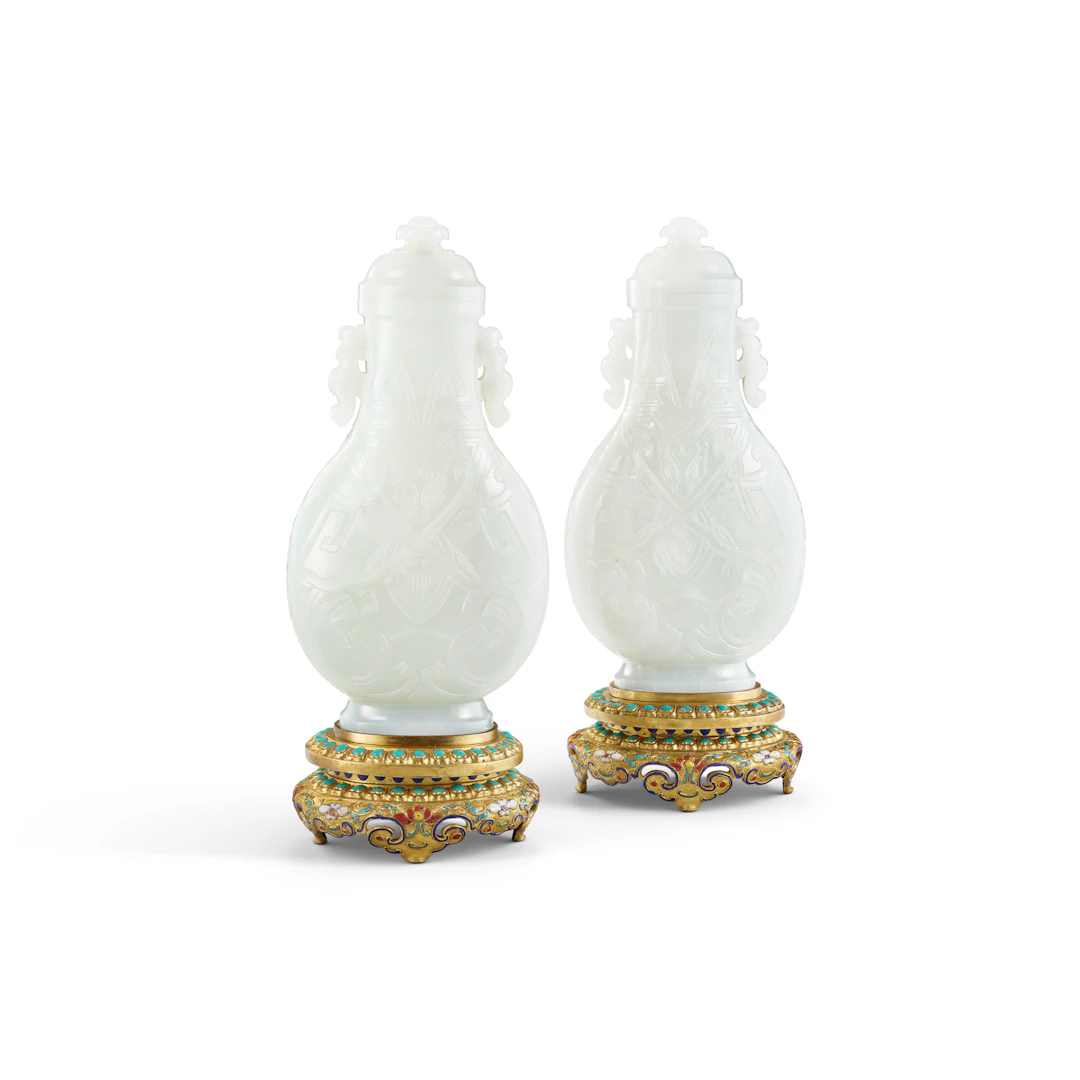 A Very Rare and Superb Pair of Archaistic White Jade 'Dragon' Vases and Covers