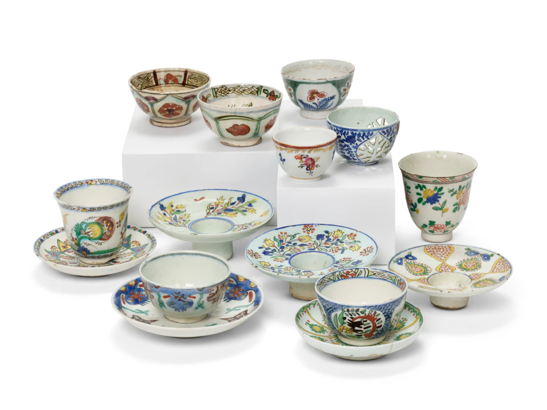 A Group of Kütahya Pottery Cups, Saucers and Candle Holders