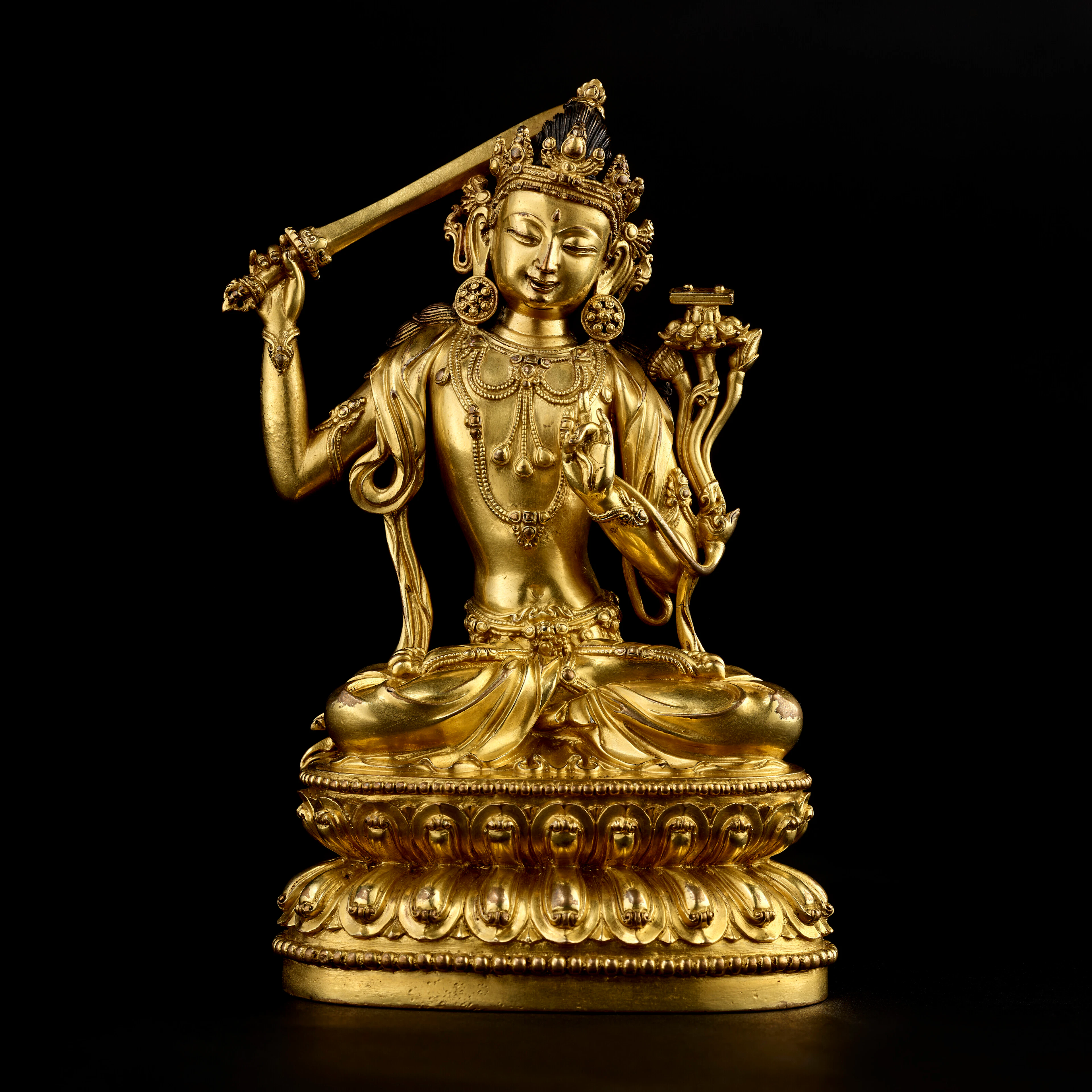 A GILT COPPER ALLOY FIGURE OF MANJUSHRI