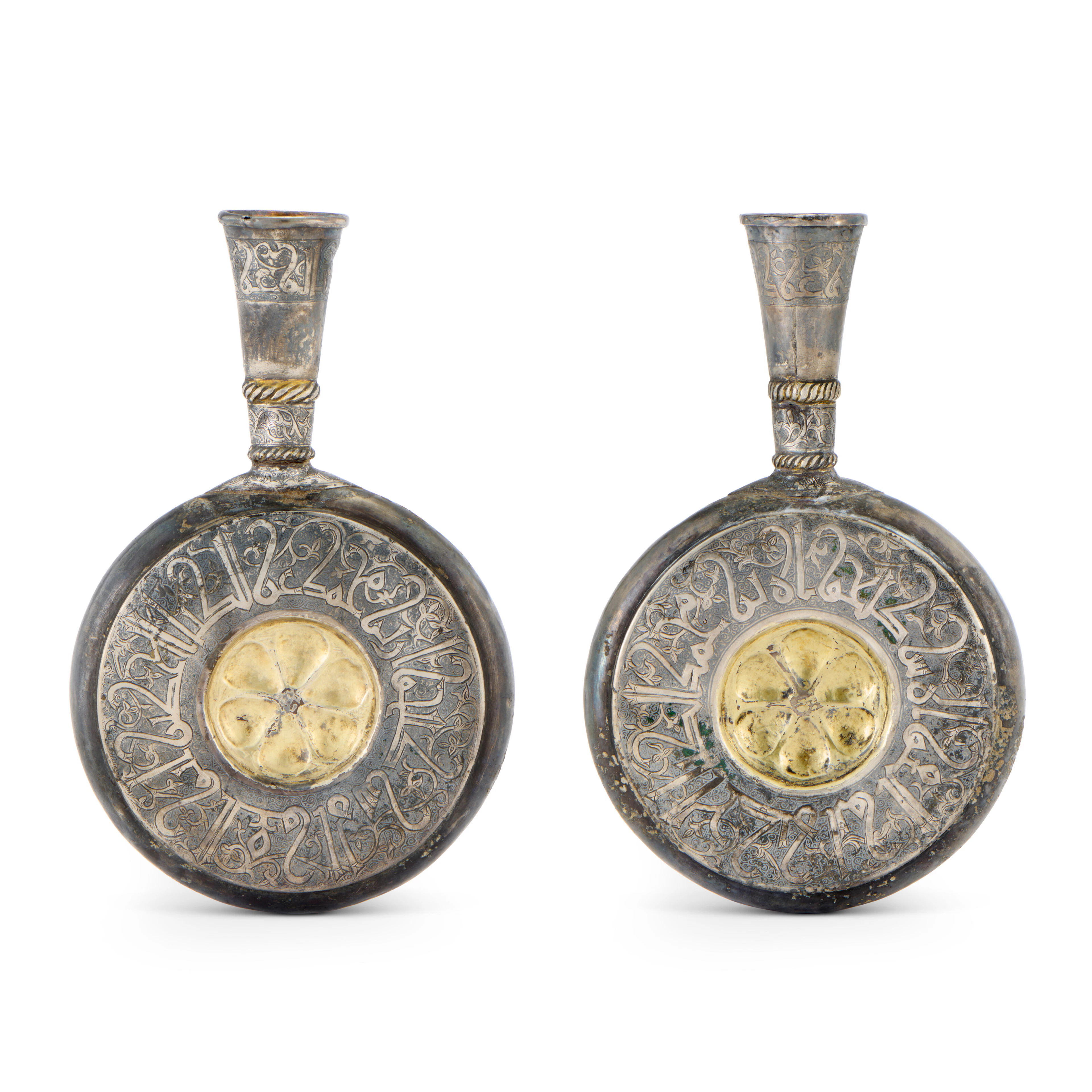A PAIR OF GILT AND NIELLOED SILVER PILGRIM FLASKS