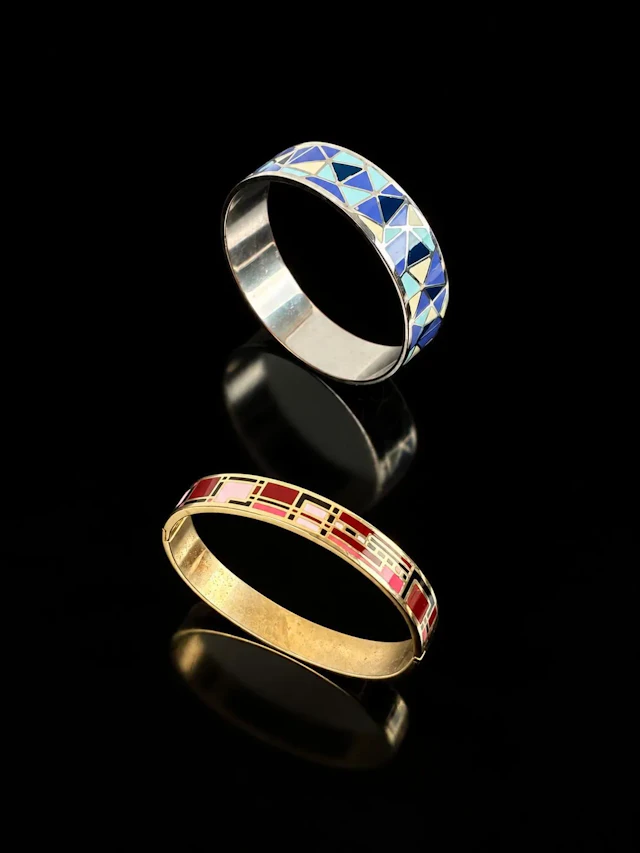 A set of two bangle bracelets: one is a gold-tone metal bang - Lot 195