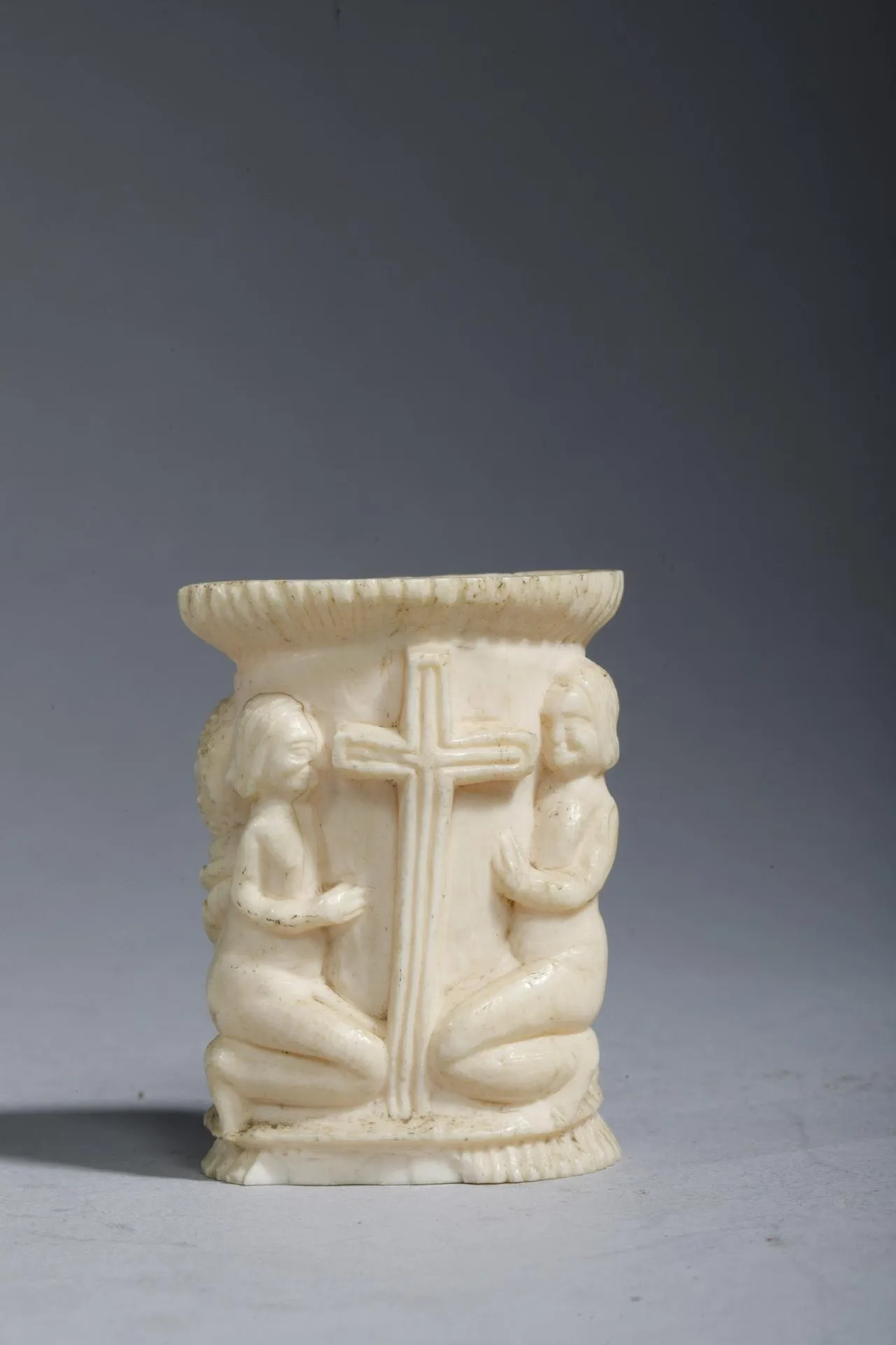 Small bone jar carved with two figures—a woman and a man—in - Lot 140