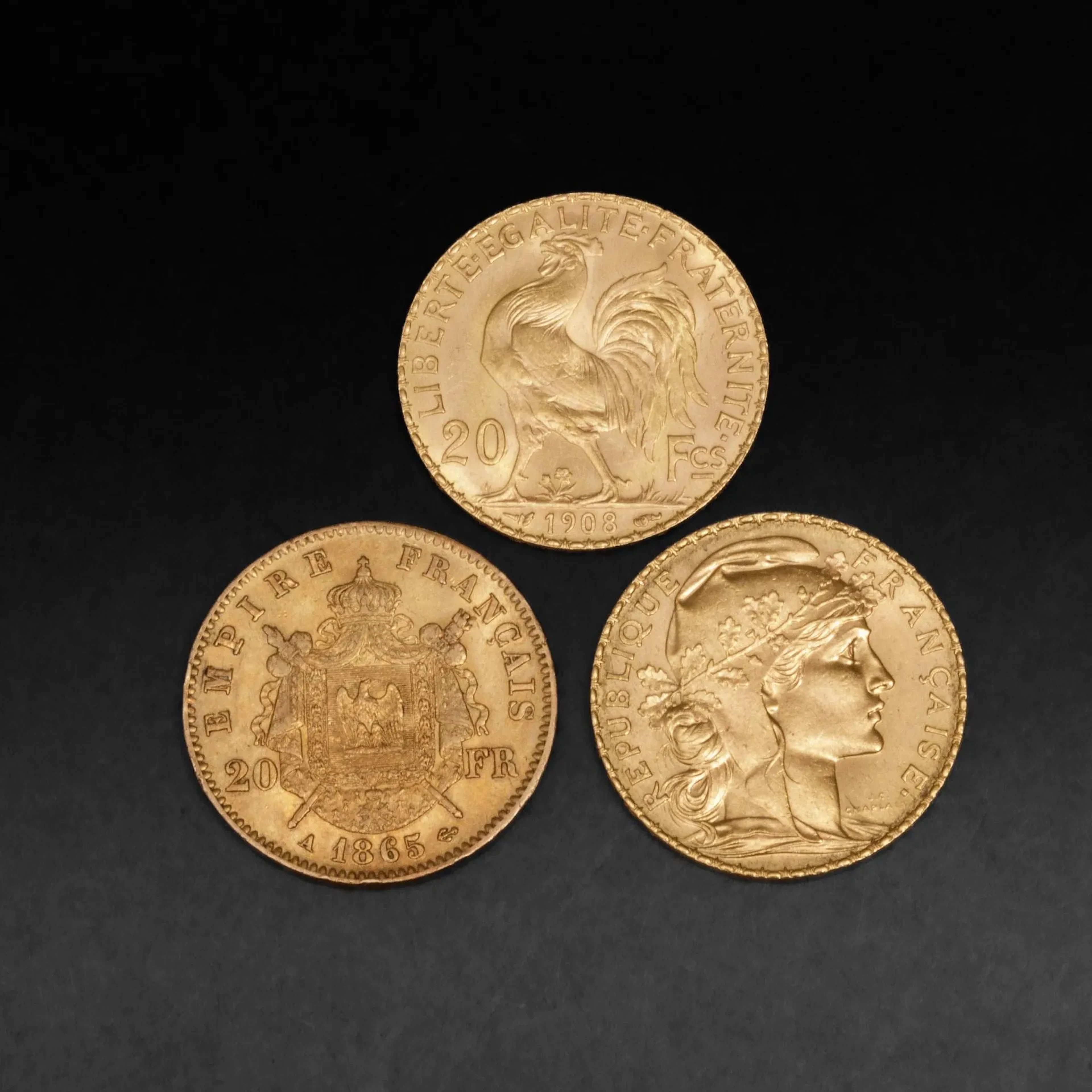 Three 20-franc gold coins (two featuring a rooster and one a - Lot 1