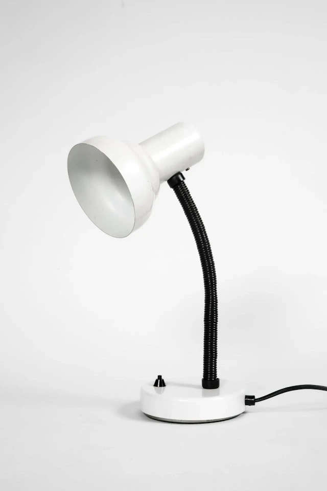 White lacquered metal desk lamp on a flexible arm, with an a - Lot 184