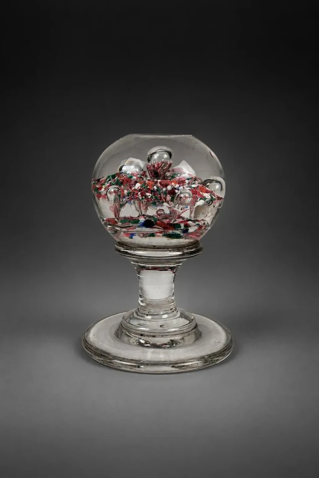 A crystal paperweight mounted on a pedestal - Lot 101