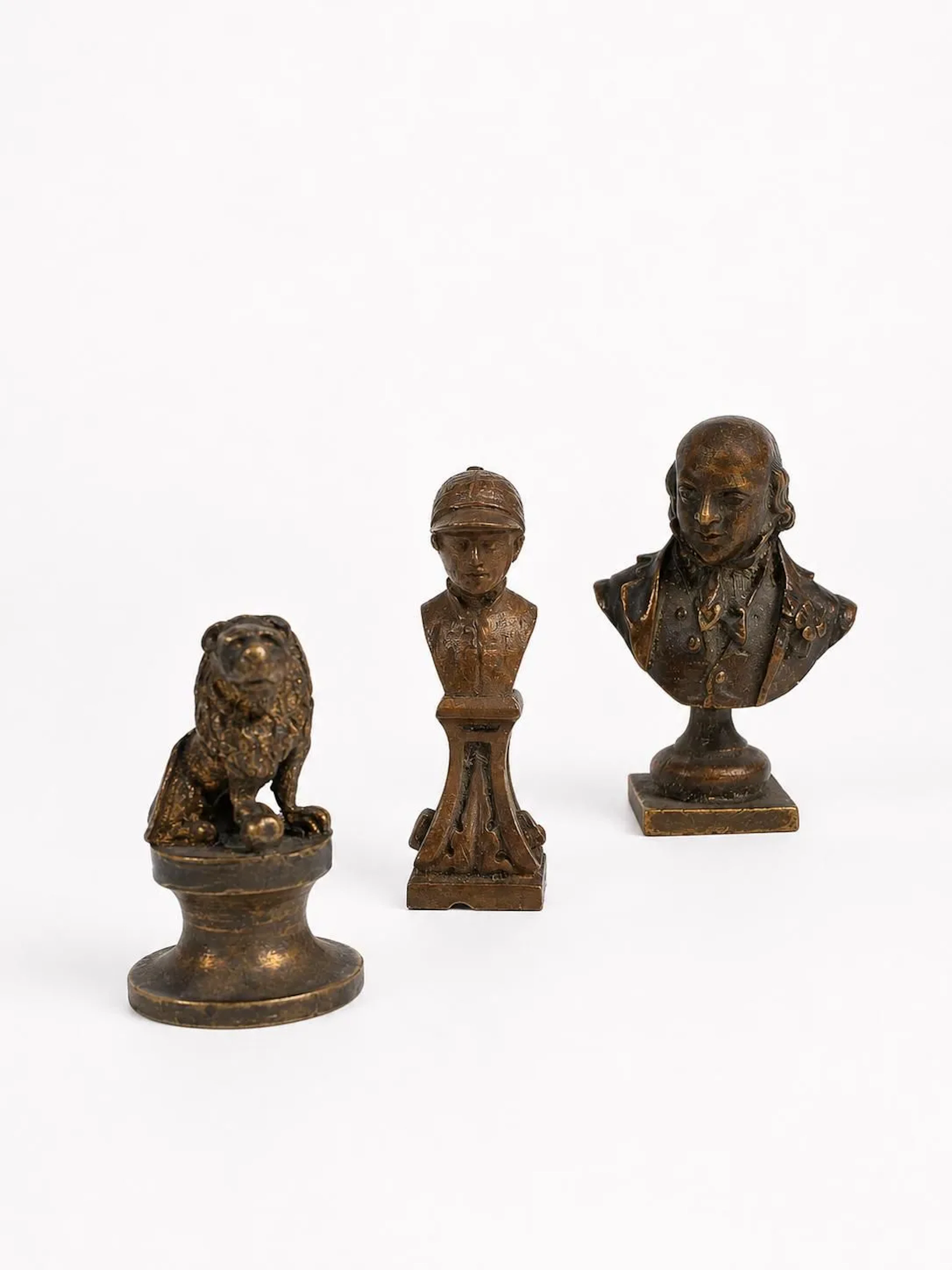 A set of three small bronze seals with a medal-like patina, - Lot 373