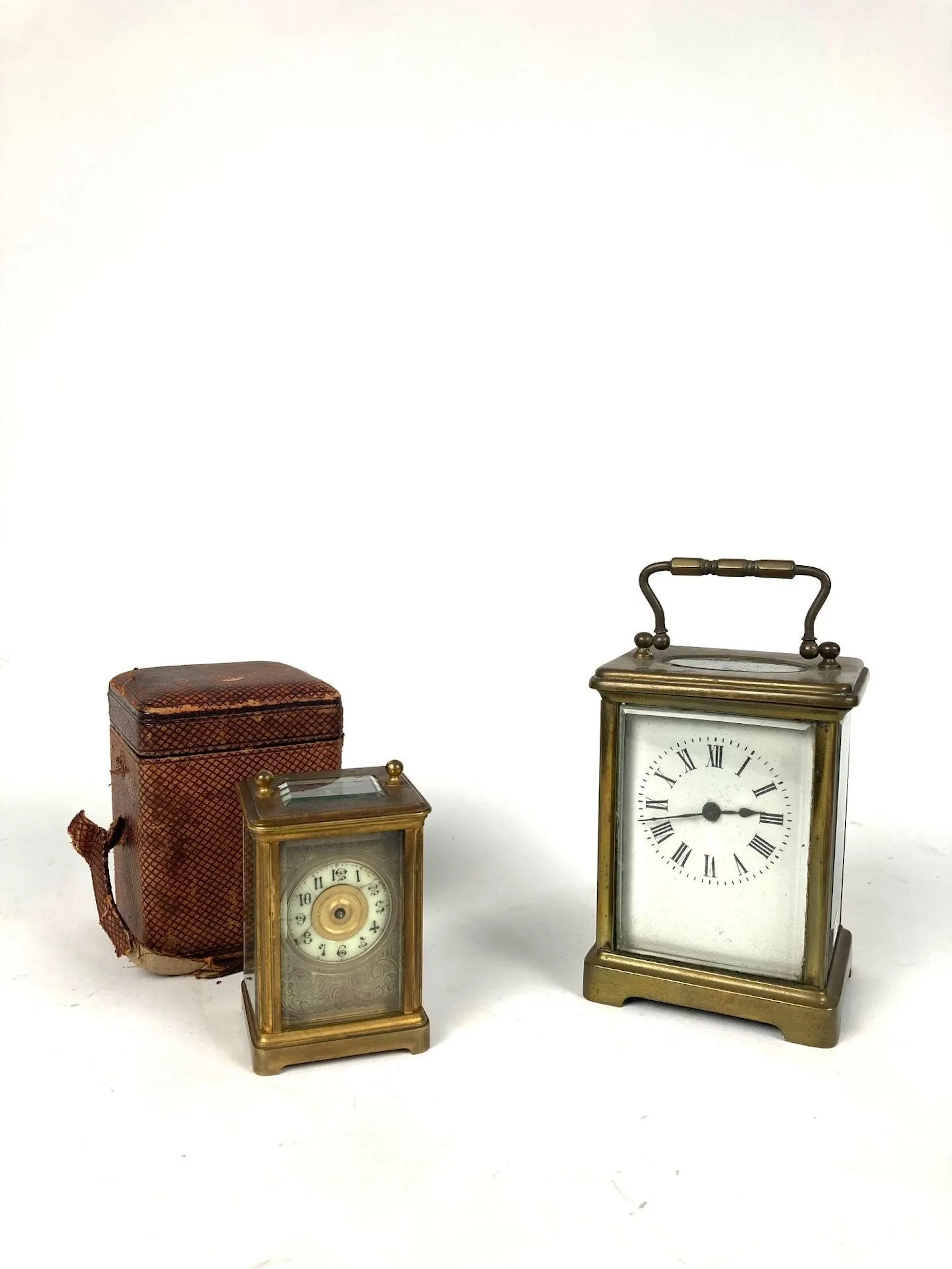 Set of two brass and beveled glass officer's clocks, one in - Lot 43