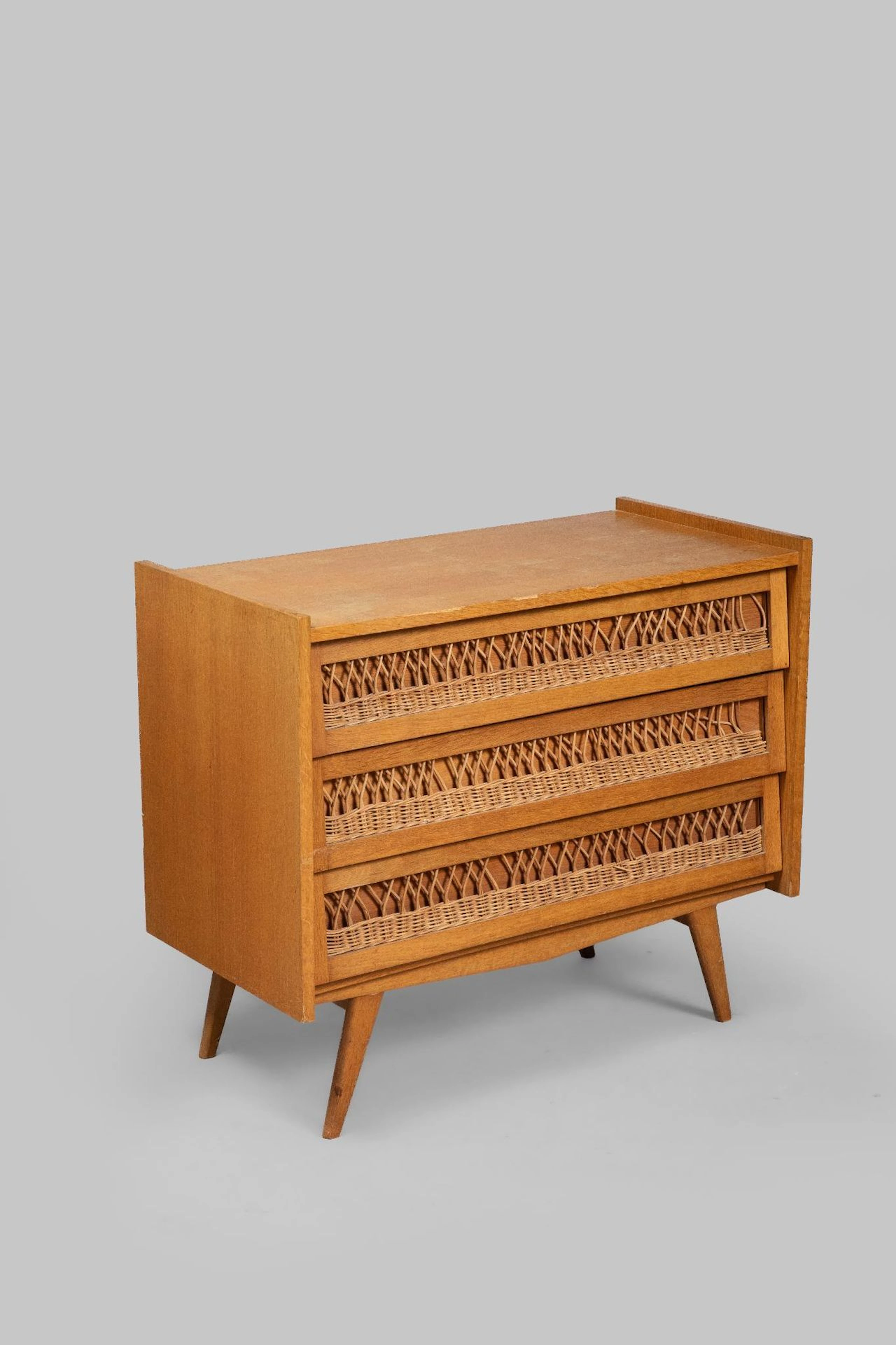 Rattan chest of drawers opening to three drawers resting on - Lot 104