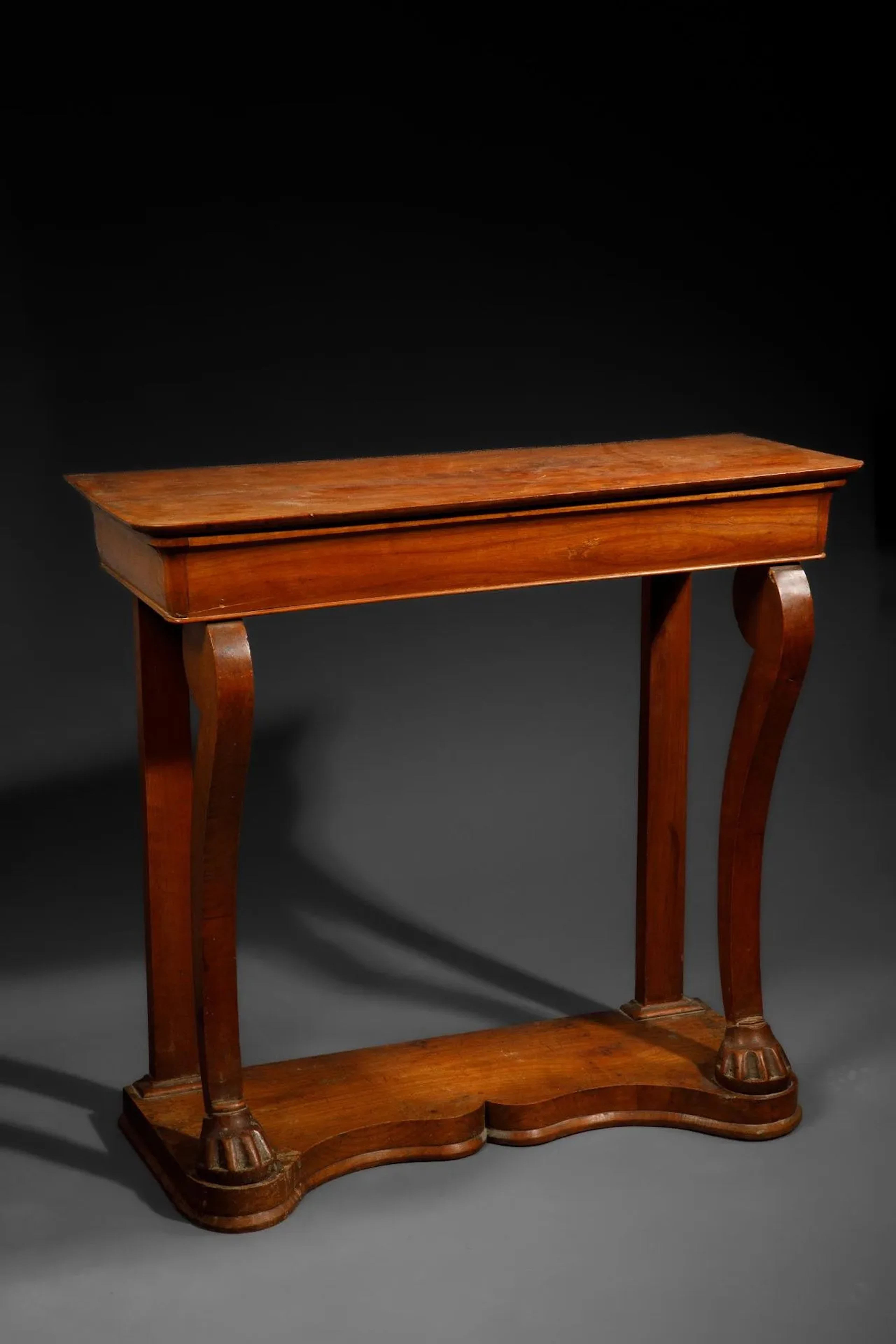 Light wood console table resting on two curved legs with lio - Lot 348