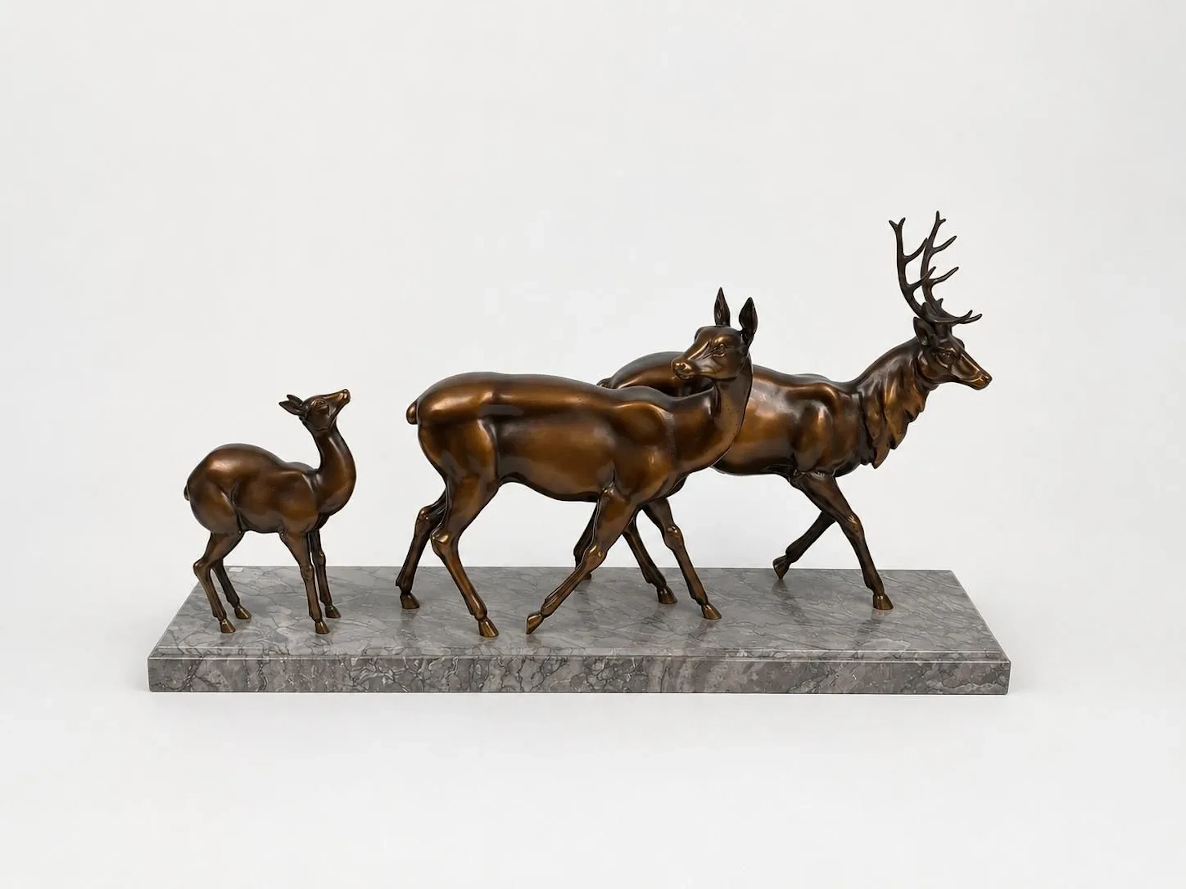 A life-size sculpture depicting a family of deer—a doe and a - Lot 495