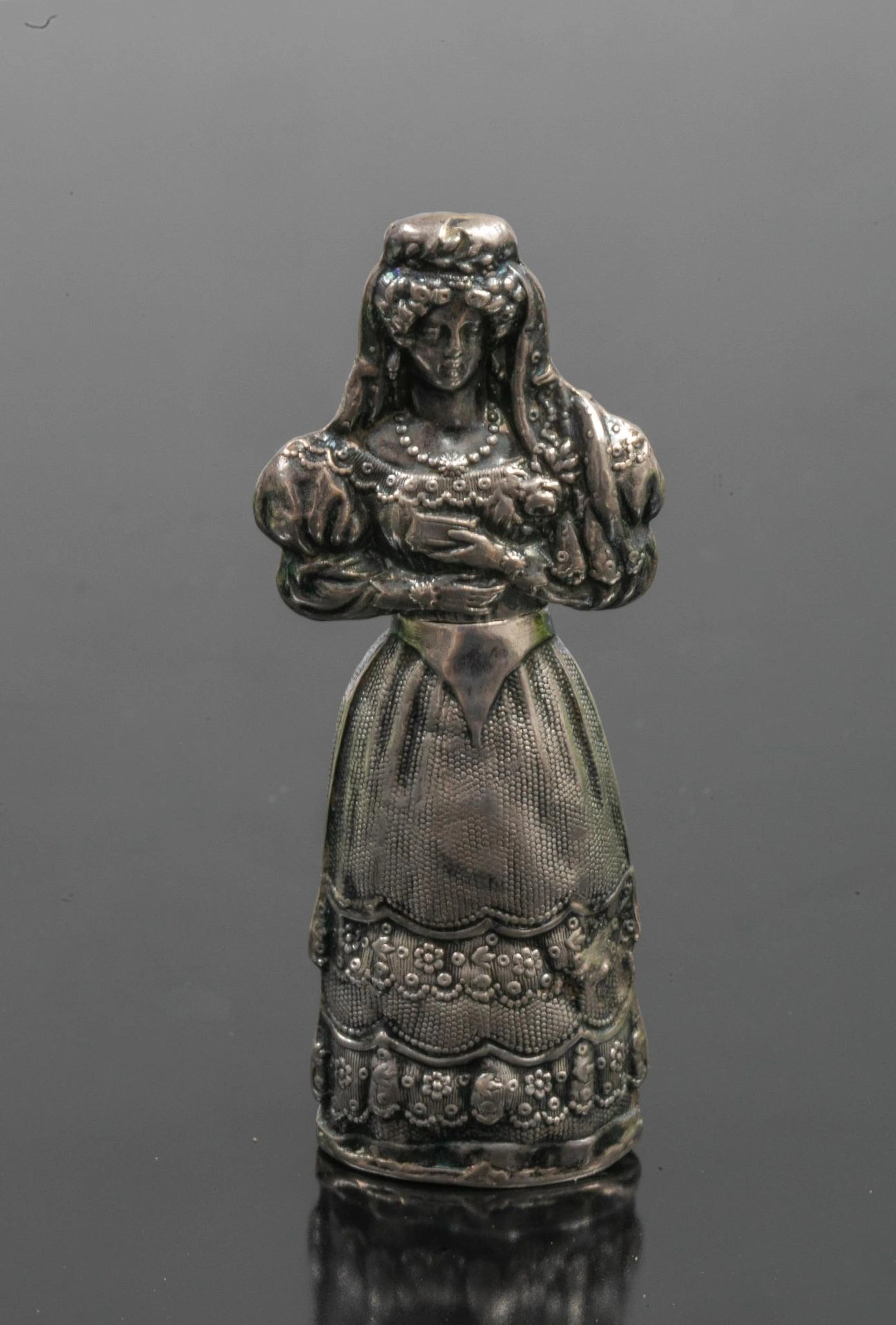 repoussé silver needle case in the shape of a bride with bou - Lot 249